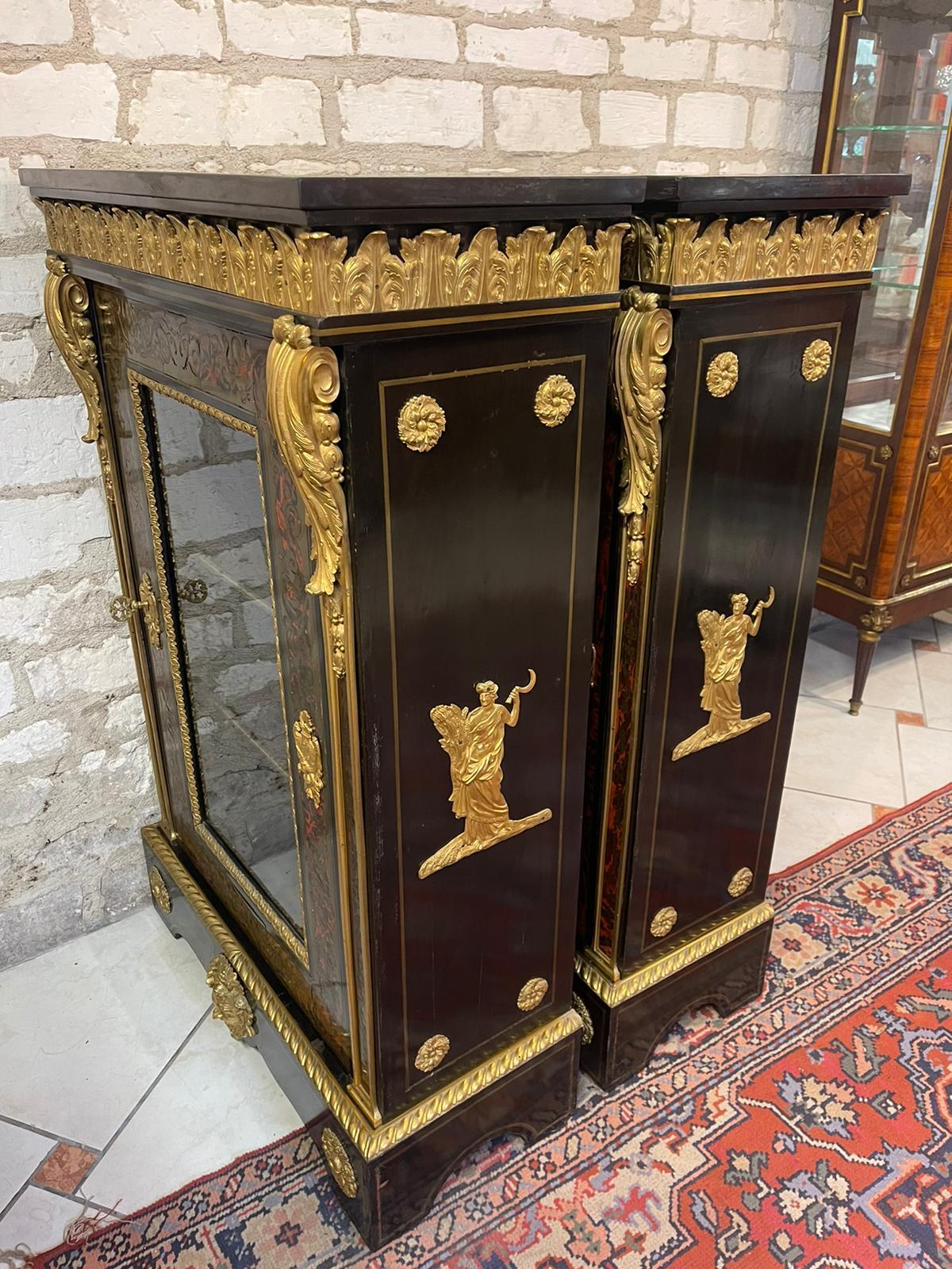 Pair of Napoleon III period cabinets in Boulle marquetry with rich gilt bronze decoration. Black marble tops. Two interior shelves. Complete with keys.

Measures: Length : 80
Height : 124
Depth : 35,50.