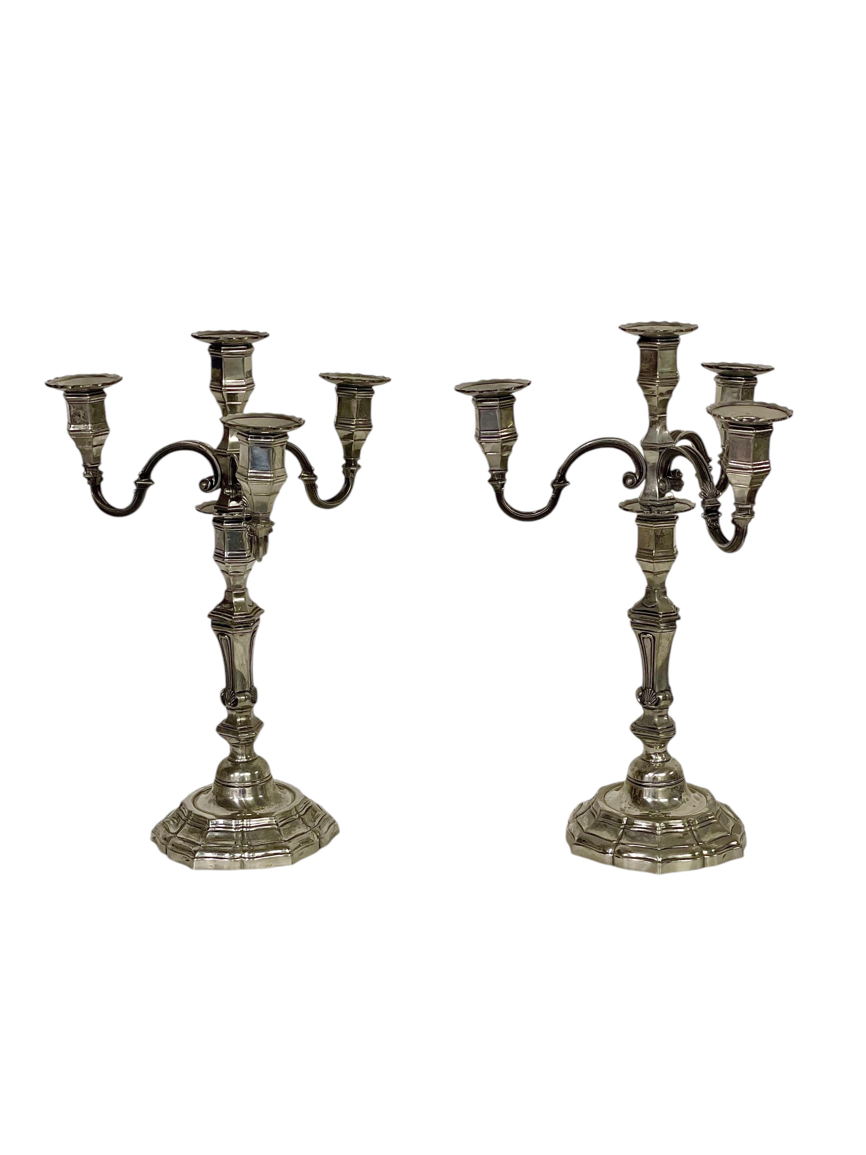 This exquisite pair of silvered metal candelabra embodies the elegance and sophistication of the Napoleon III period. Each candelabrum features three gracefully curved arms, each terminating in a cup to hold a candle, and a central baluster of