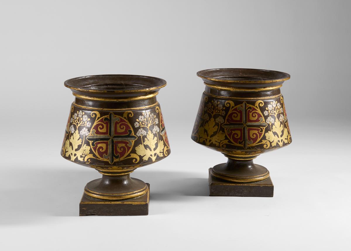 Retaining their original polychromy in the neo-Gothic style, these pieces represent a trend typical of the Second Empire—large planters intended for exterior spaces with either intricate relief designs or significant embossing or painting. The