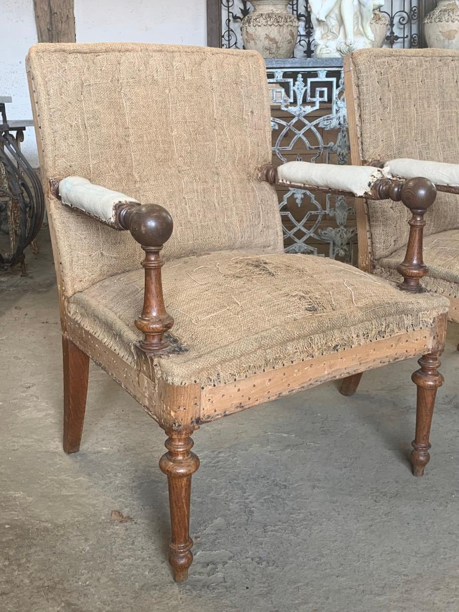 A nice pair of French oak Napoleon lll armchairs in a very unusual and rare style with the balls on the arms. Ready for new upholstery.