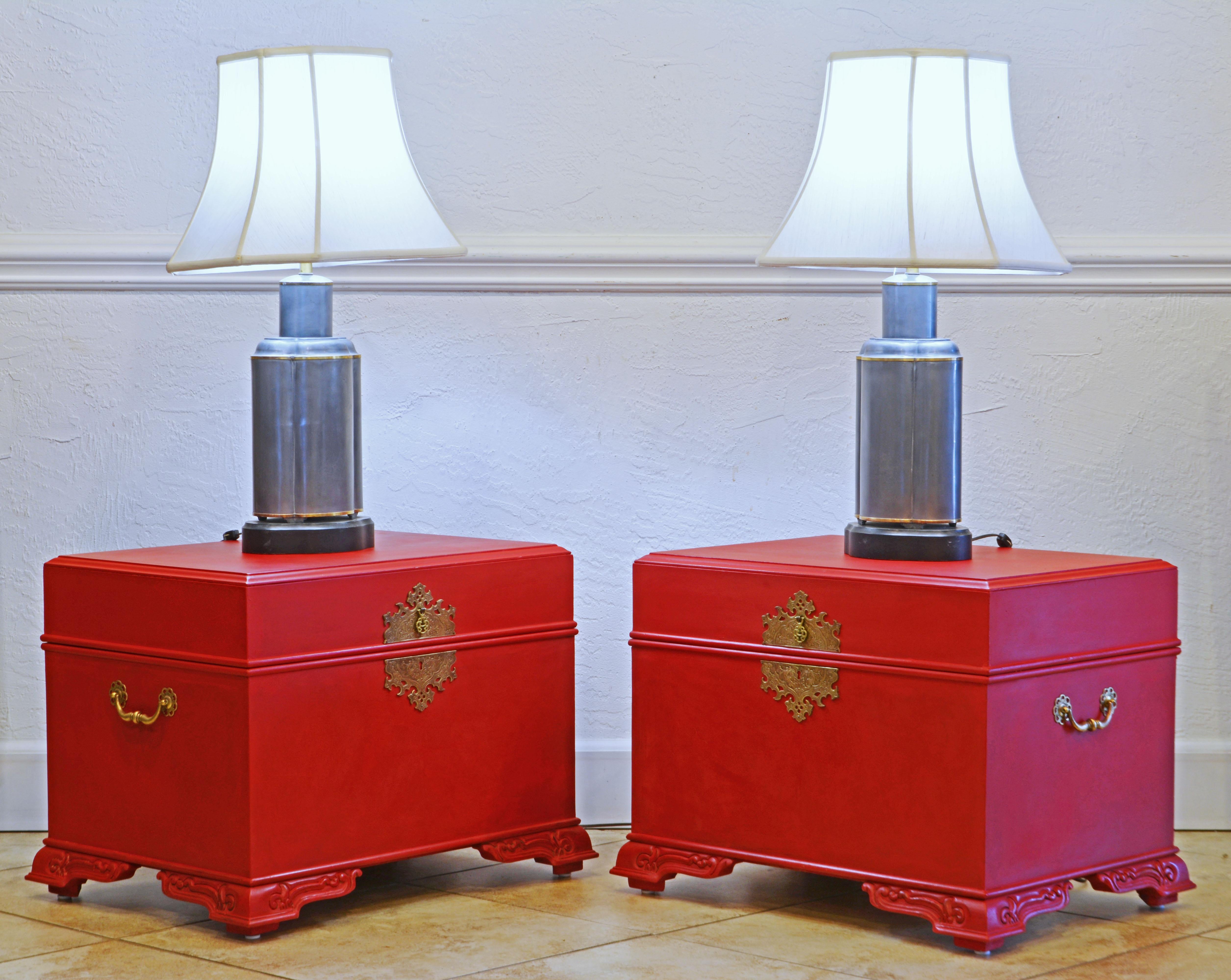 This pair of footed red lacquered chests or side tables feature tops that opens up to storage compartments with sliding compartments for smaller items. The Narra/Baul style chests are often from the Philippines where they for centuries have served