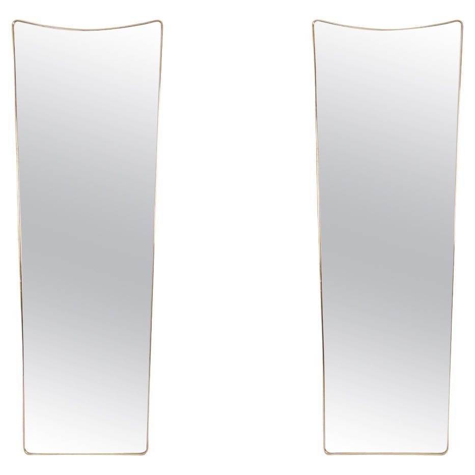 Pair of narrow gilded brass mirrors. Circa 1970.