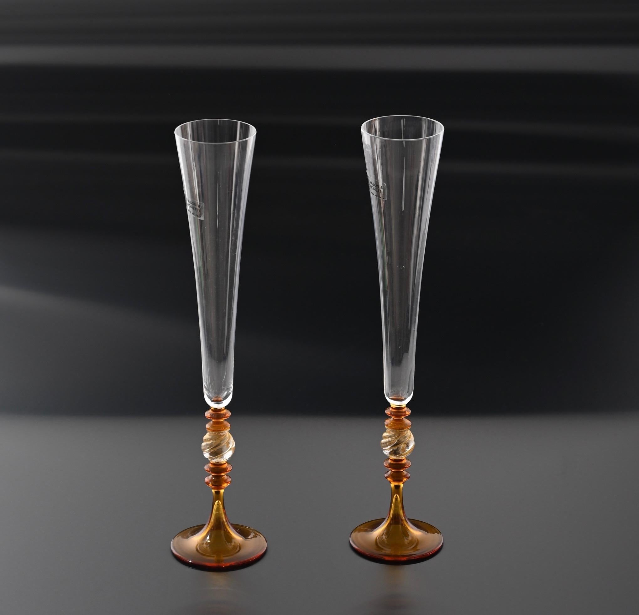 Pair of Murano crystal glass, amber and gold goblets glasses. Nason and Moretti designed these fantastic pieces in Murano, Venice, during the 1980s.

This set of champagne glasses has luxurious golden dust into the orange amber, and constantly