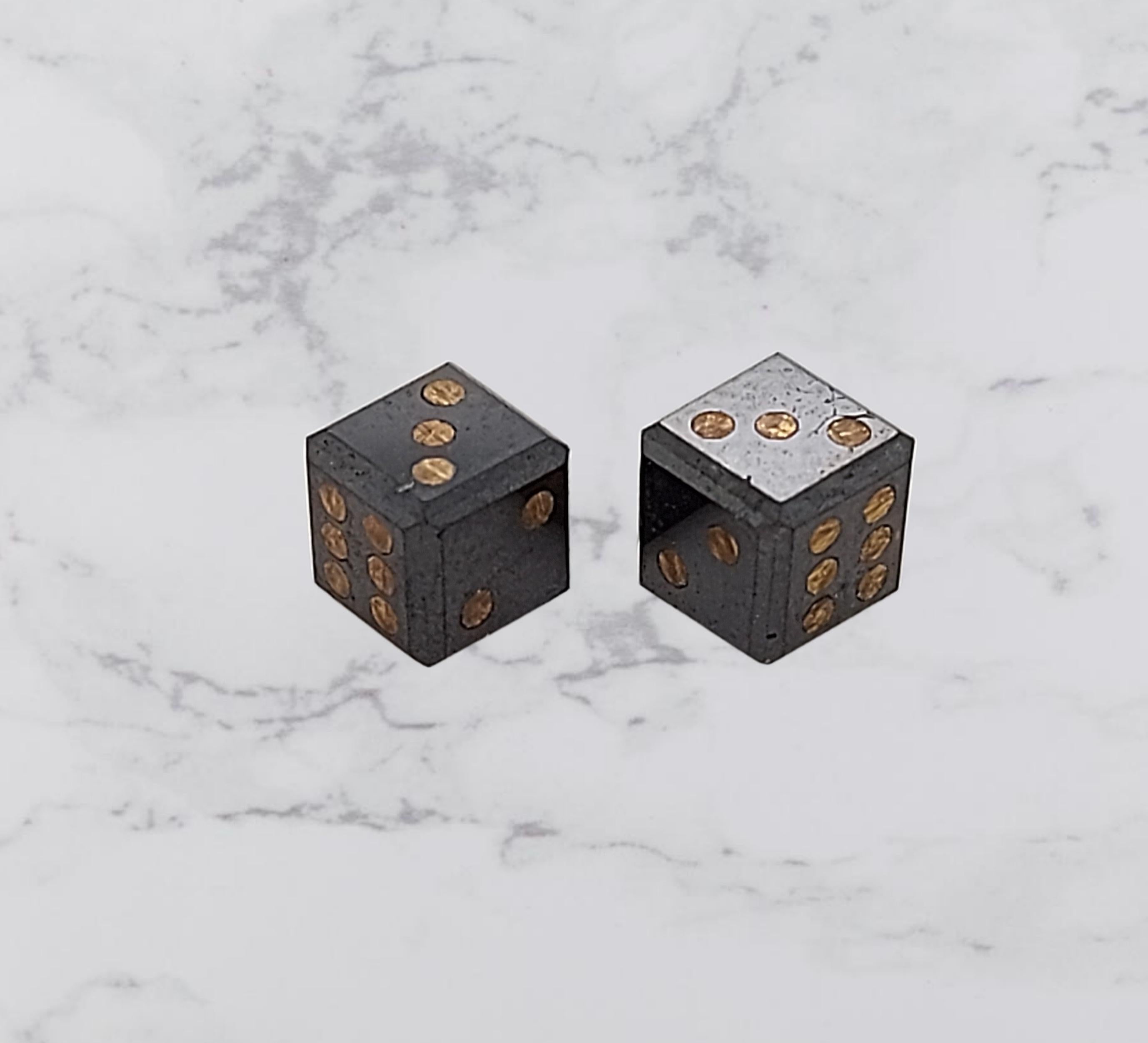 Pair of natural 2,17 Carat Black Diamond Cubes / Dice with gold inlay, 4 mm

The dice are inlaid with gold dots to mark their numbers.
The purity of the gold is not tested.

Measurements: 4 mm x 4 mm

Total weight: 0.4 gram / 0.015 oz / 0.3