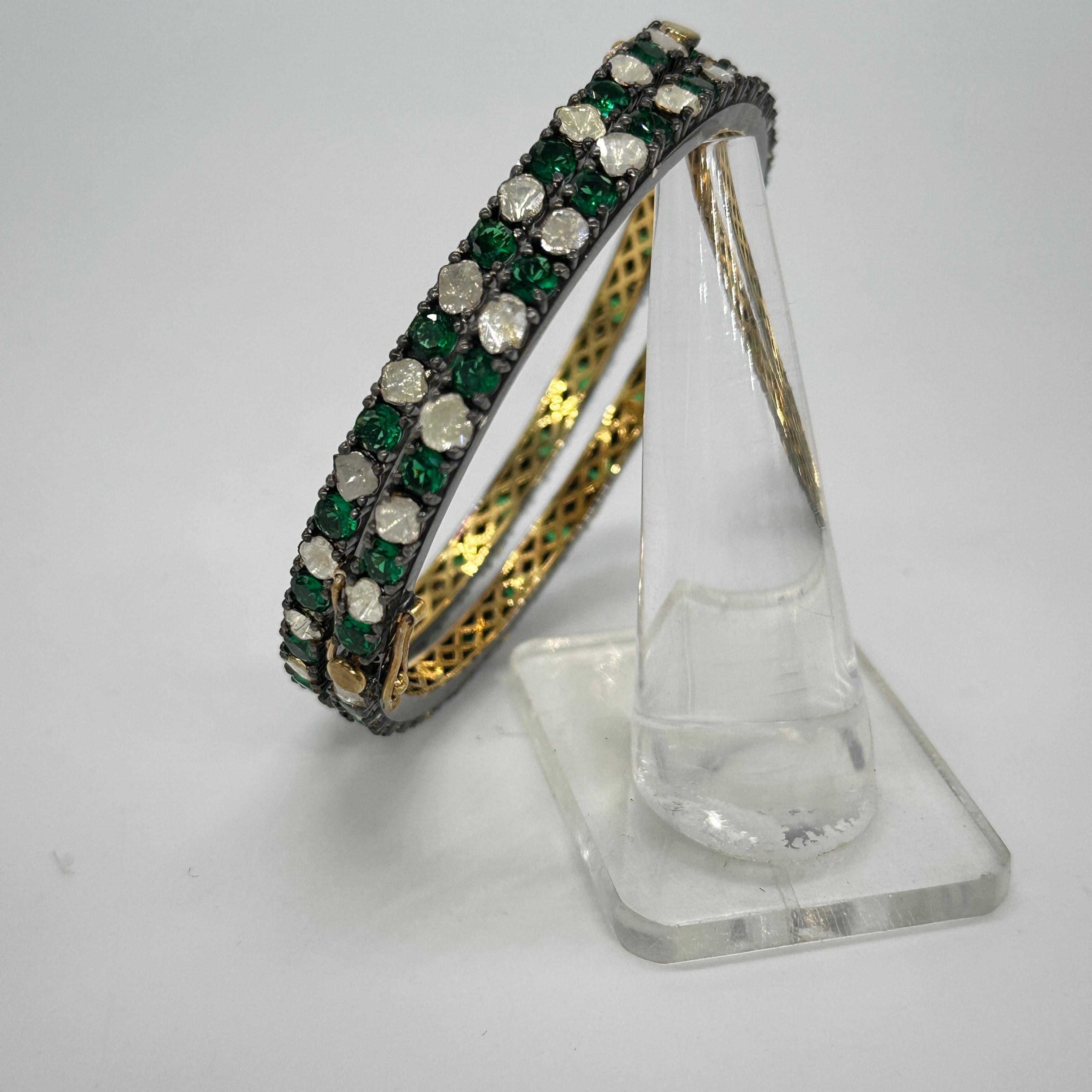 A pair of beautiful diamond emerald bangle consists of:

Diamond- 10.40cts
Diamond type: uncut polki diamond
Diamond color: White with tint of yellow
Diamond Certificate- IGI Certified
Metal: Silver
Metal Purity: Sterling Silver or 92.5% Pure
Metal