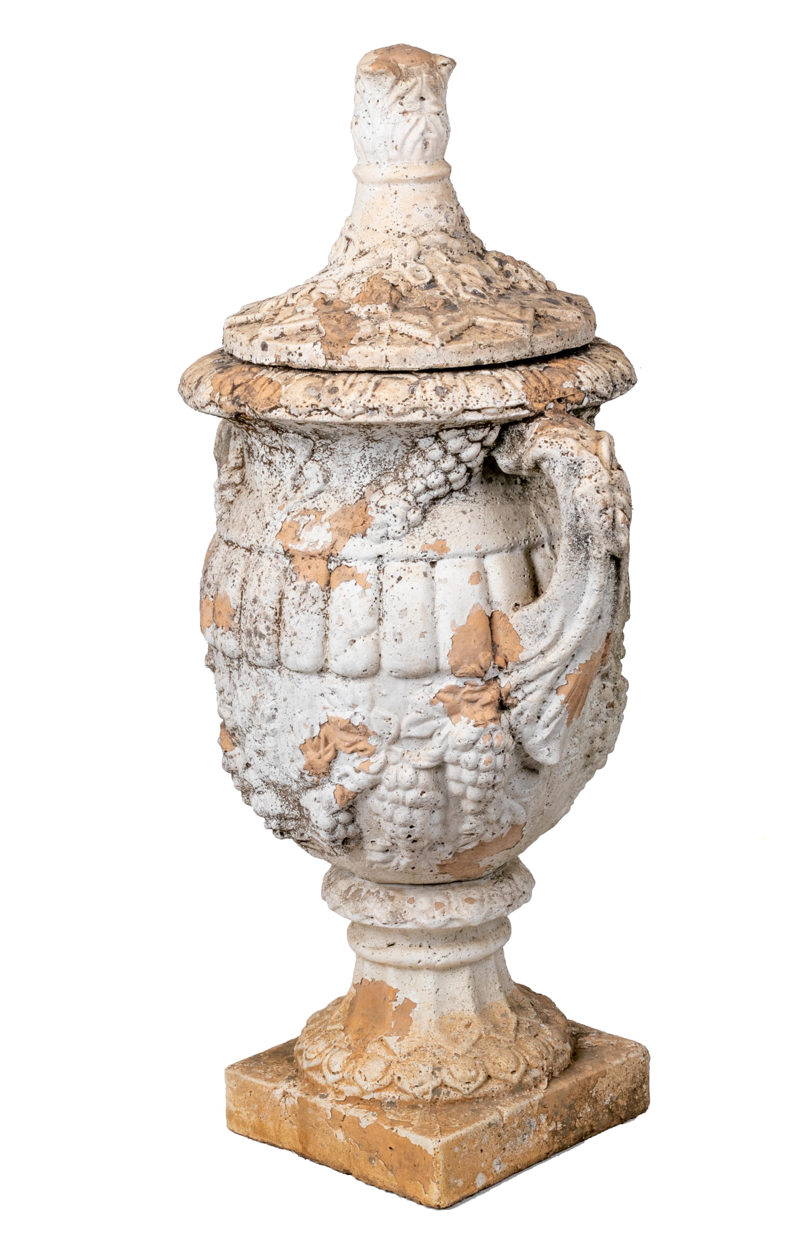 Pair of natural French terracotta urns with lids.