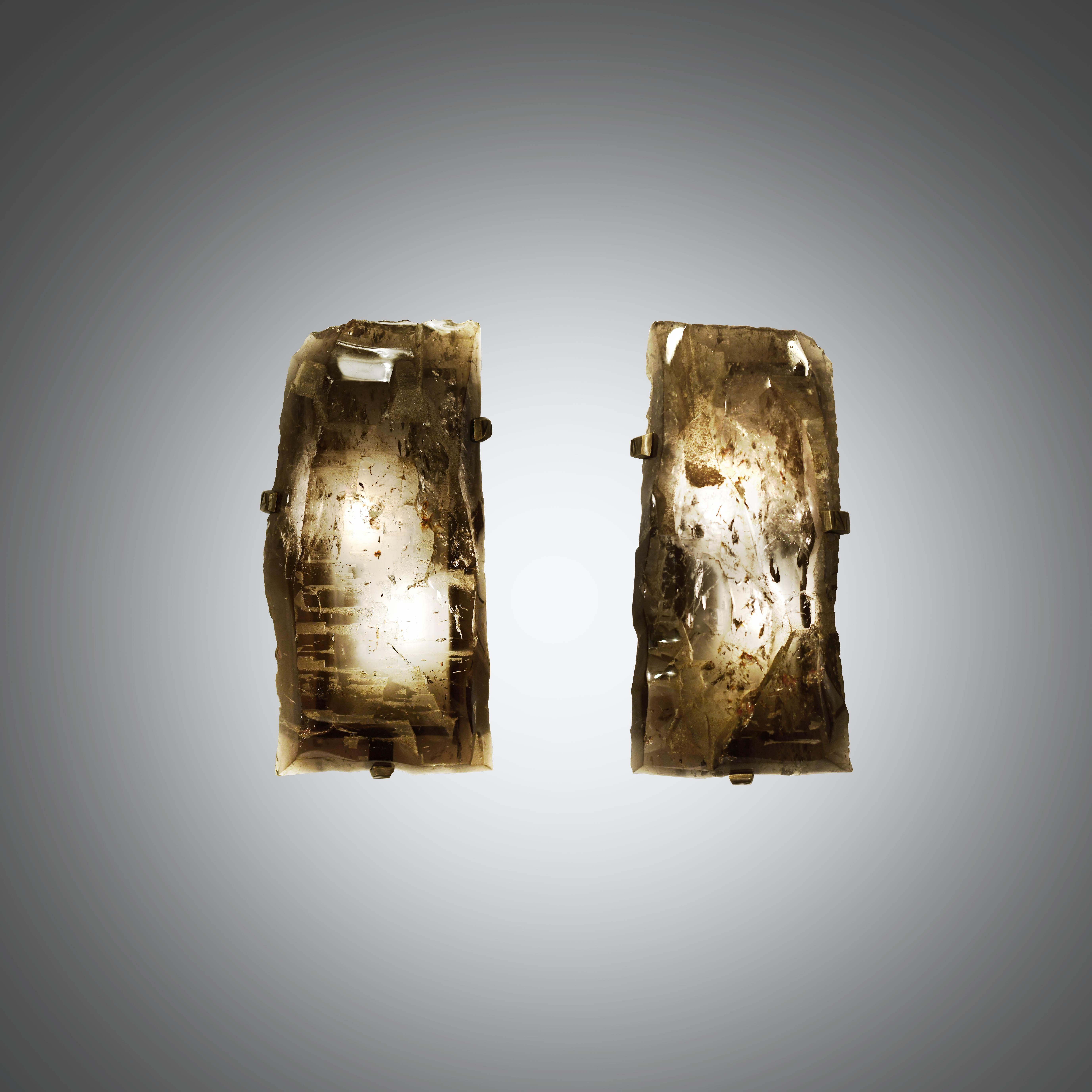 Pair of natural smoky rock crystal quartz wall sconces with antique brass-mounted, selected from natural rock crystal with the beautiful natural surface. Created by Phoenix gallery. Custom measurement and finish available. Each wall sconce is