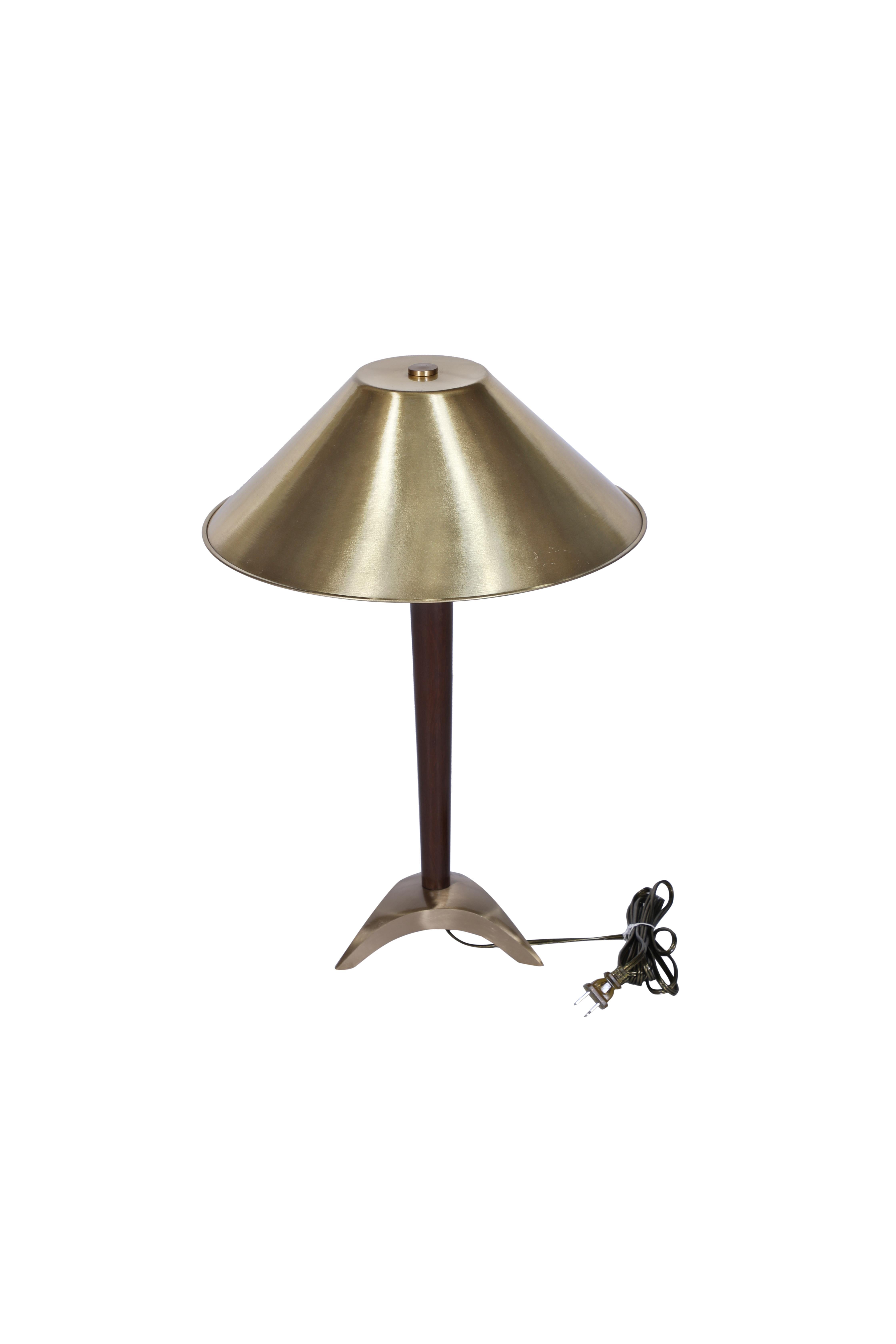 A pair of nautical brass and teak table lamps from the stateroom of a decommissioned ship.  Shade is also brass in a conical shape and has a a tripod base.  Circa 1970's.  Rewired for American use. Takes a standard base bulb.

The Lockhart