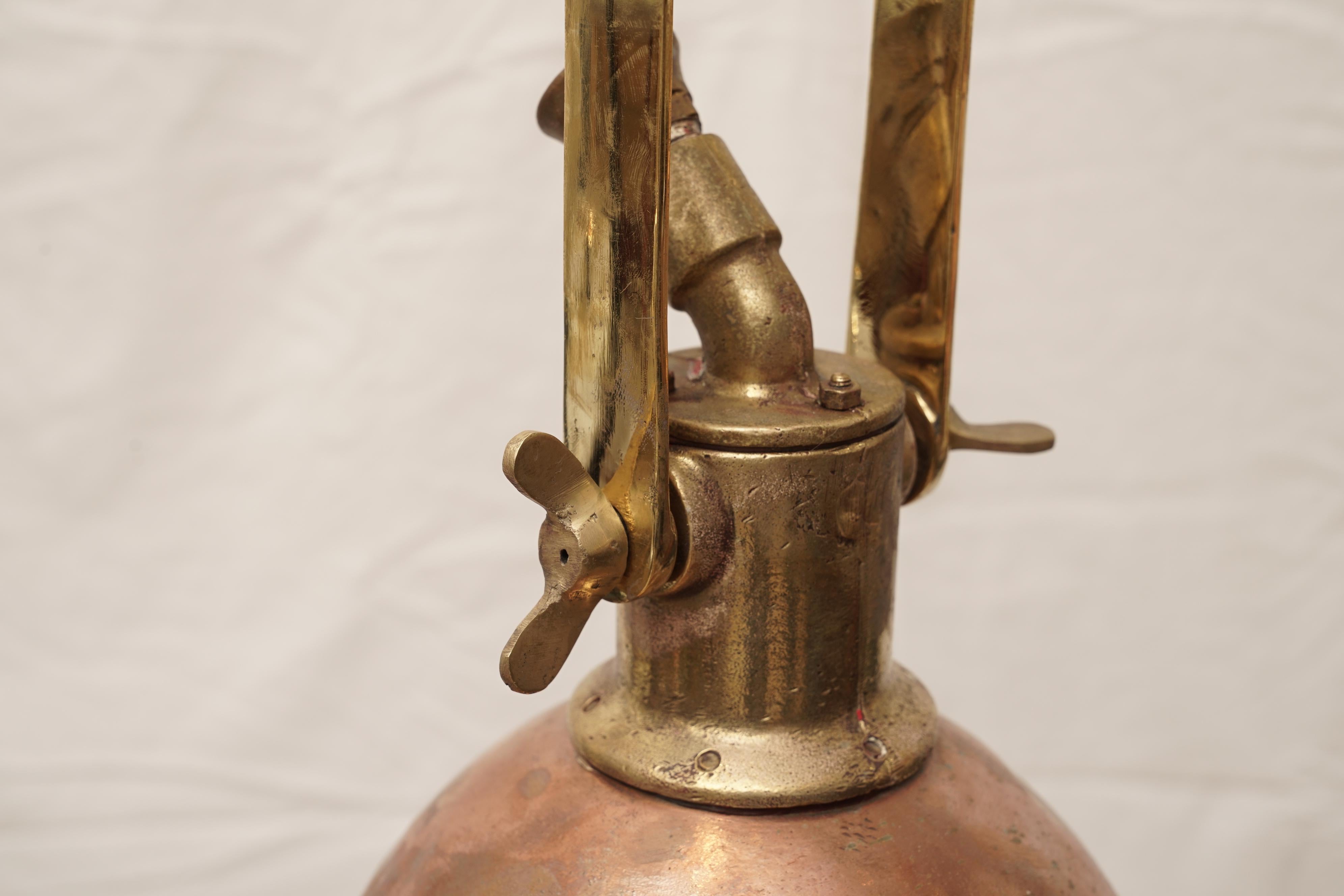 Two copper and brass ship's deck lights originally used to load and unload cargo at night, circa 1970s. They have been rewired for American use. These were from a decommissioned European ship and still show a lovely patina though they have been