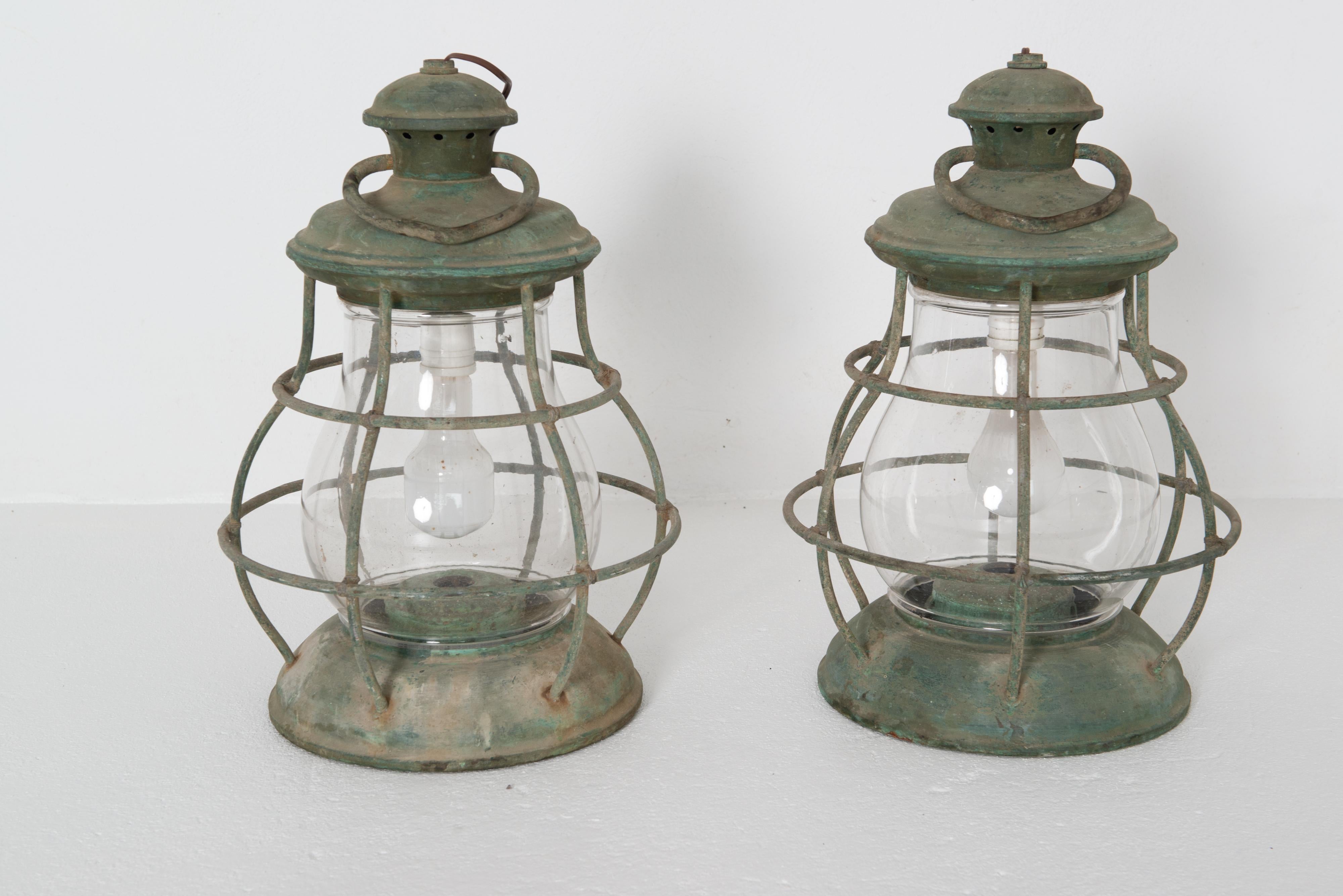 Pair of large vintage circular nautical copper lanterns with old bulbous circular glass. Large circular ring at the top of the lantern. Currently wired with with an inverted standard socket. Diameter of the base is 11 inches.
Large scale, big look.