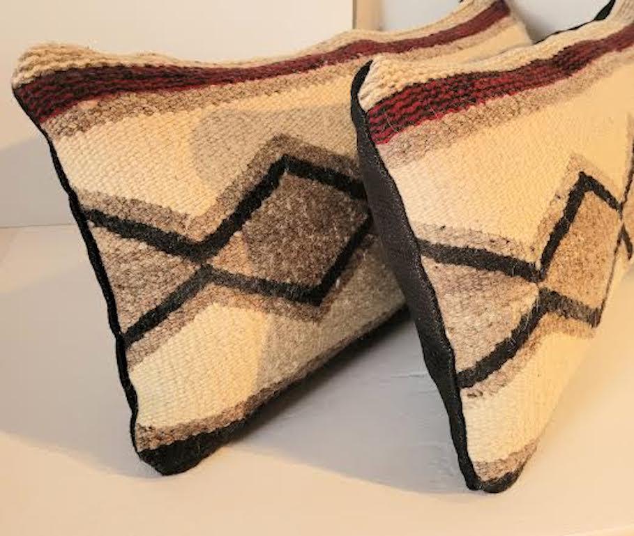 Beautiful Pair of Navajo Bolster Pillows . Off white, Taupe, kind of a light burgungy Red. Backing is a nice Linen. Feather and Down Inserts.