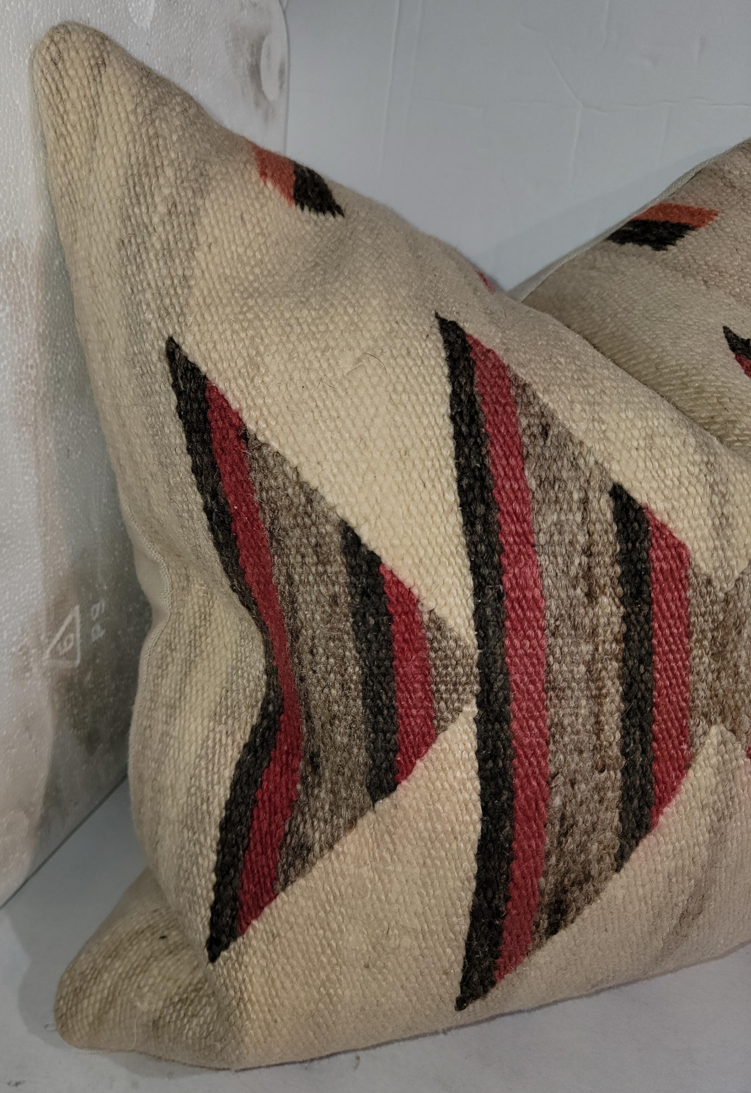 Beautiful beige background with multi color geese pattern pillow. This pillow is a great reminder if the what can be when showing reds black and neutral grays within a chosen limited pattern. Beautiful simple design choices catch your eyes. Beige