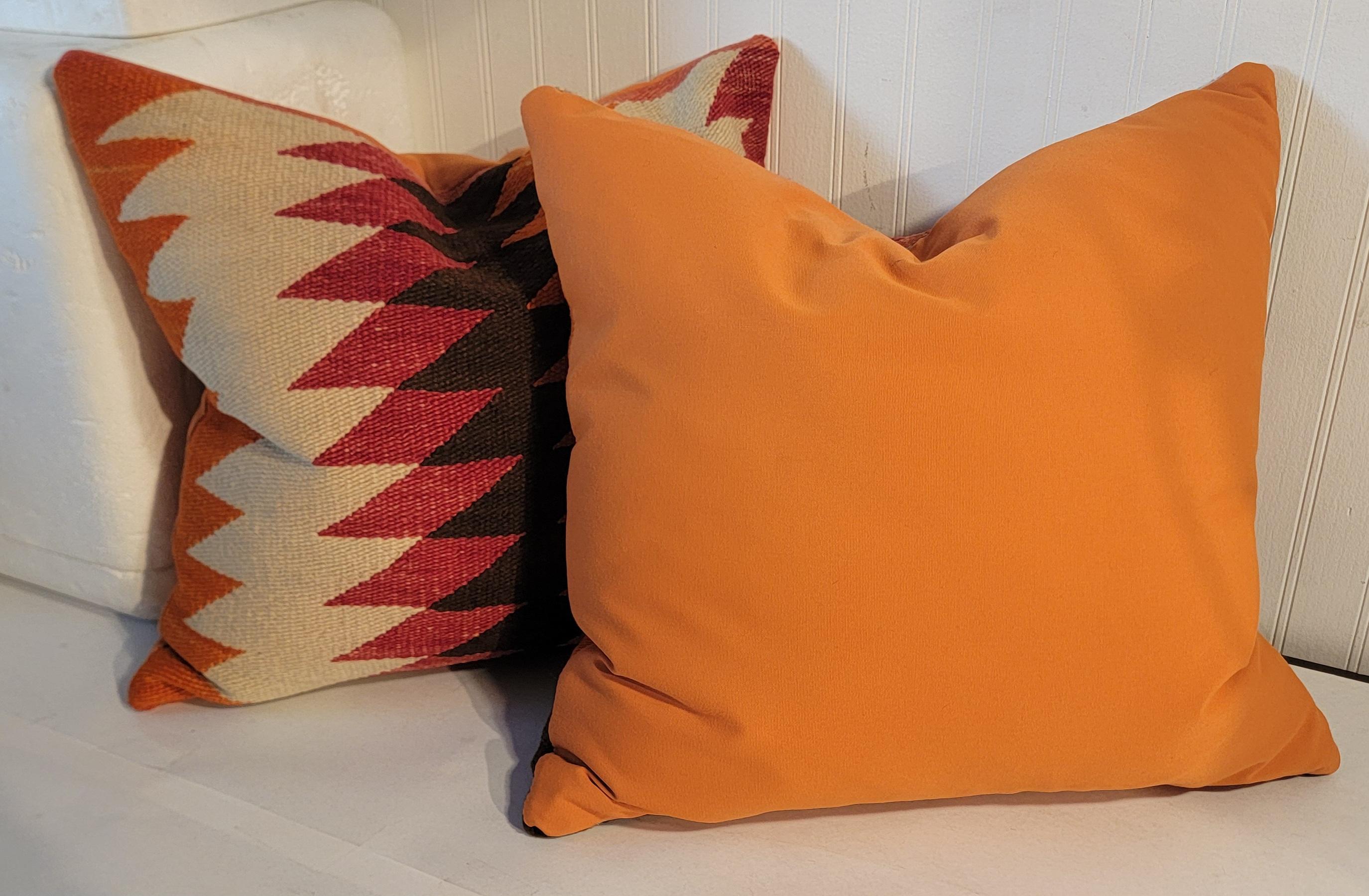 These early Navajo Indian weaving saddle blanket eye dazzler pillows are in fine condition.Sold as a pair with down 
feather fill.The backings are in a orange cotton linen.