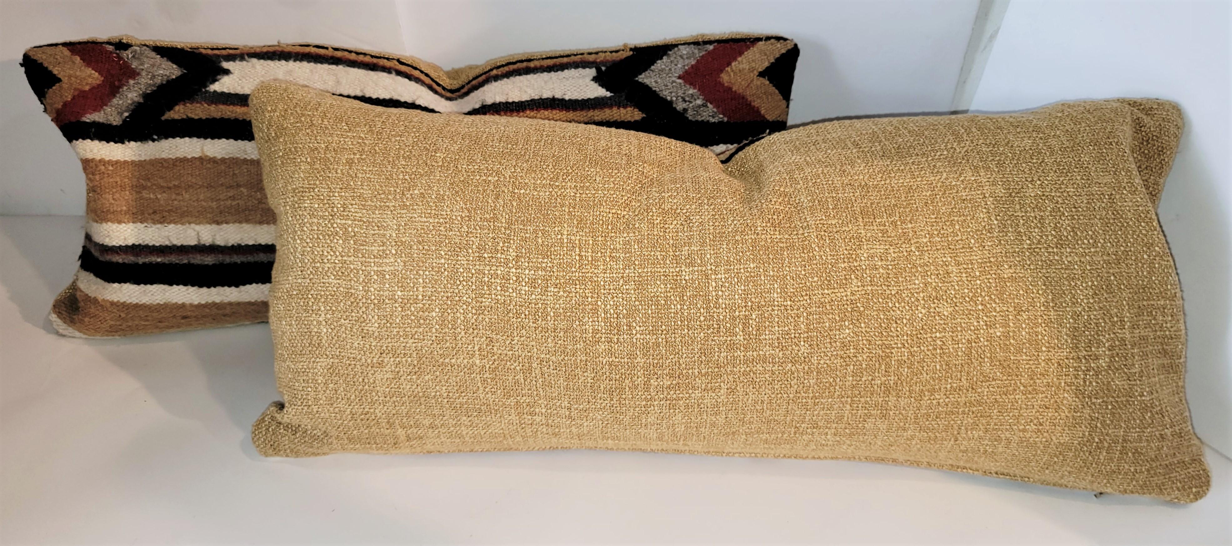 Pair of beautiful Navajo Indian weaving pillows with strips and geometric pattern.
Cotton textured backing. Down and feather insert with a zipper casing for cleaning.