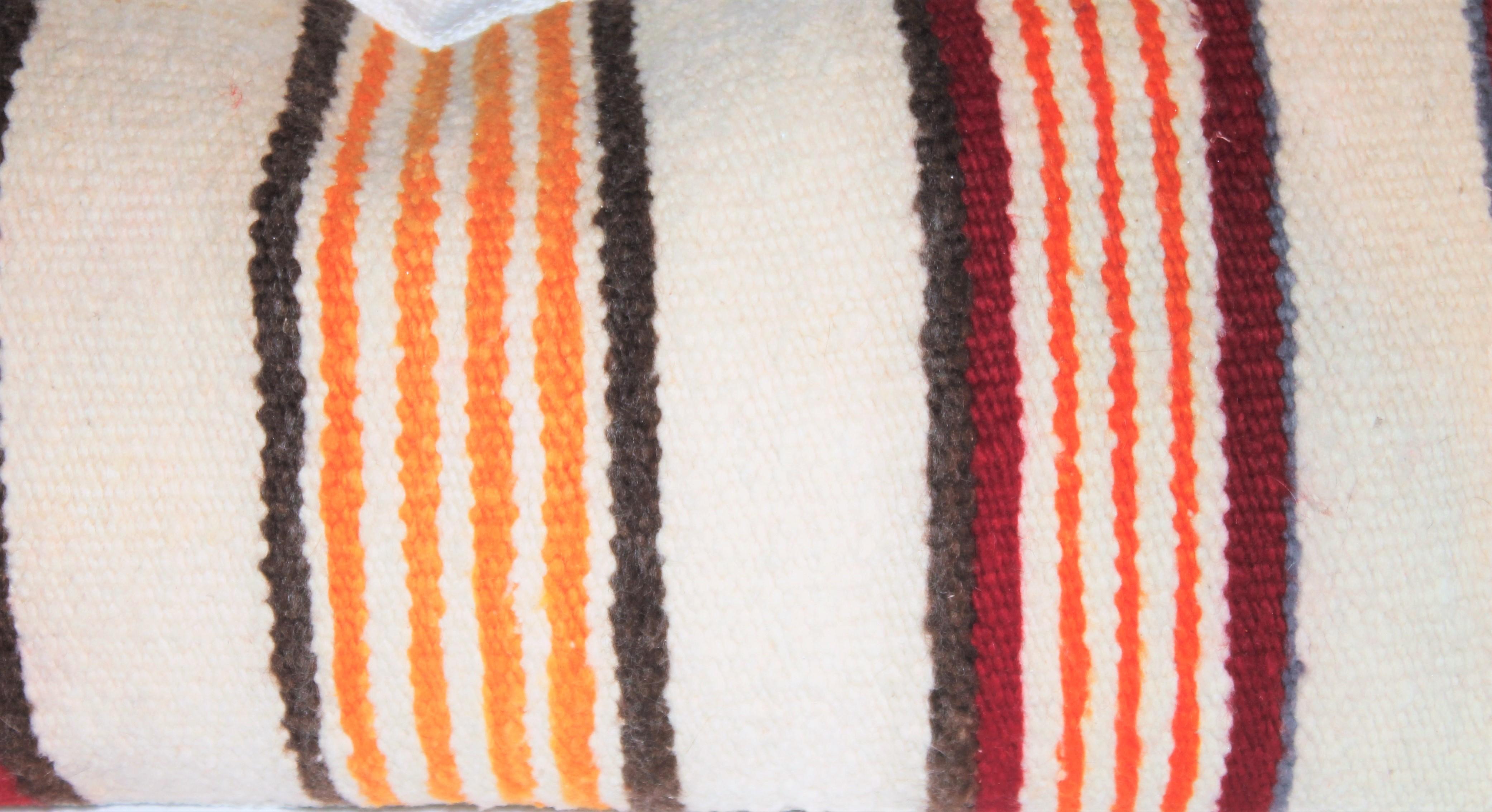 Pair of Navajo Striped bolster pillows. Feather and down inserts and zippered casing.