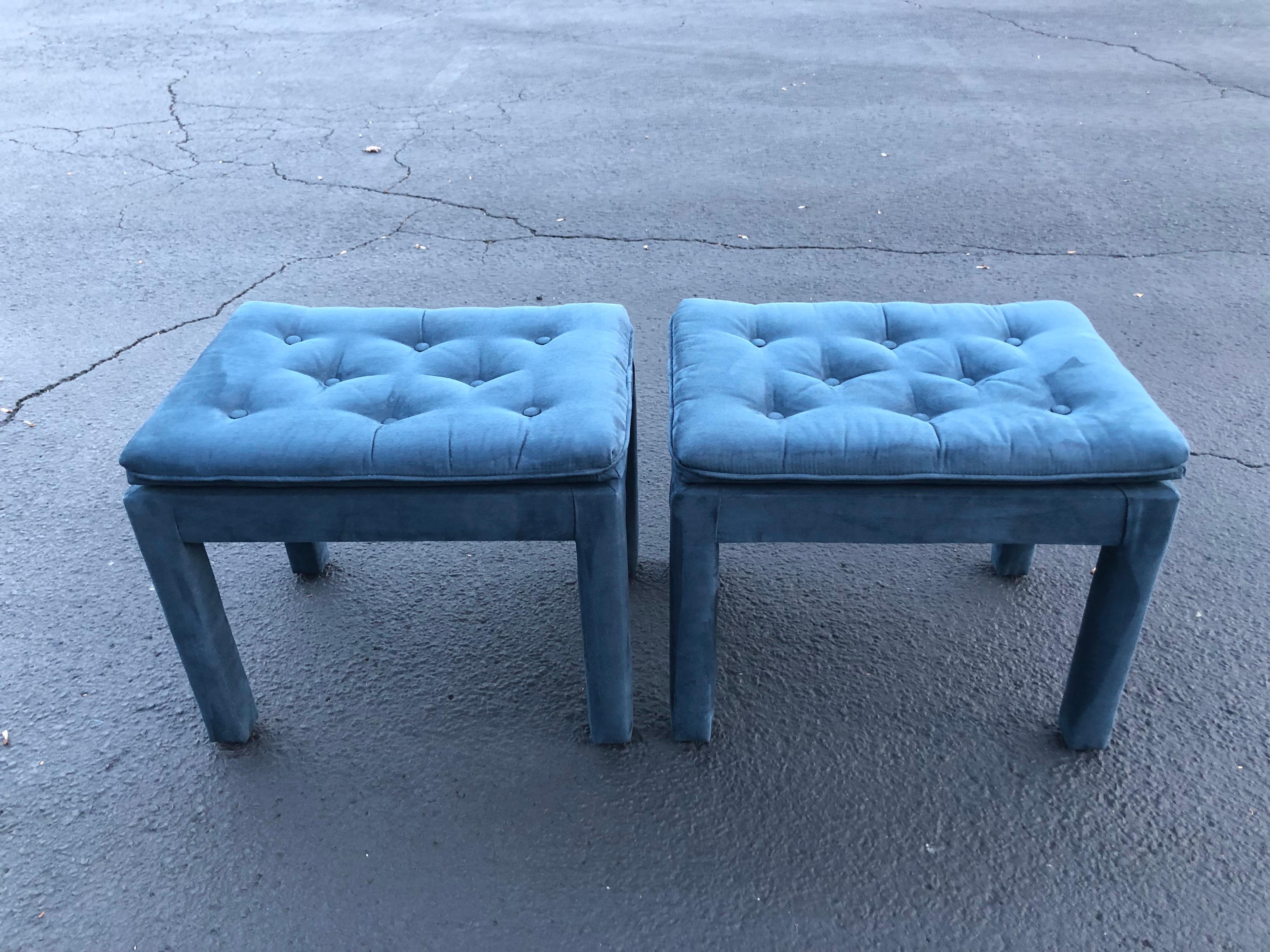 Pair of navy blue suede pillow top ottomans. Perfect for under a console or as stools in a living room. Or use in a dressing room. In the style of Billy Baldwin circa 1970-80.