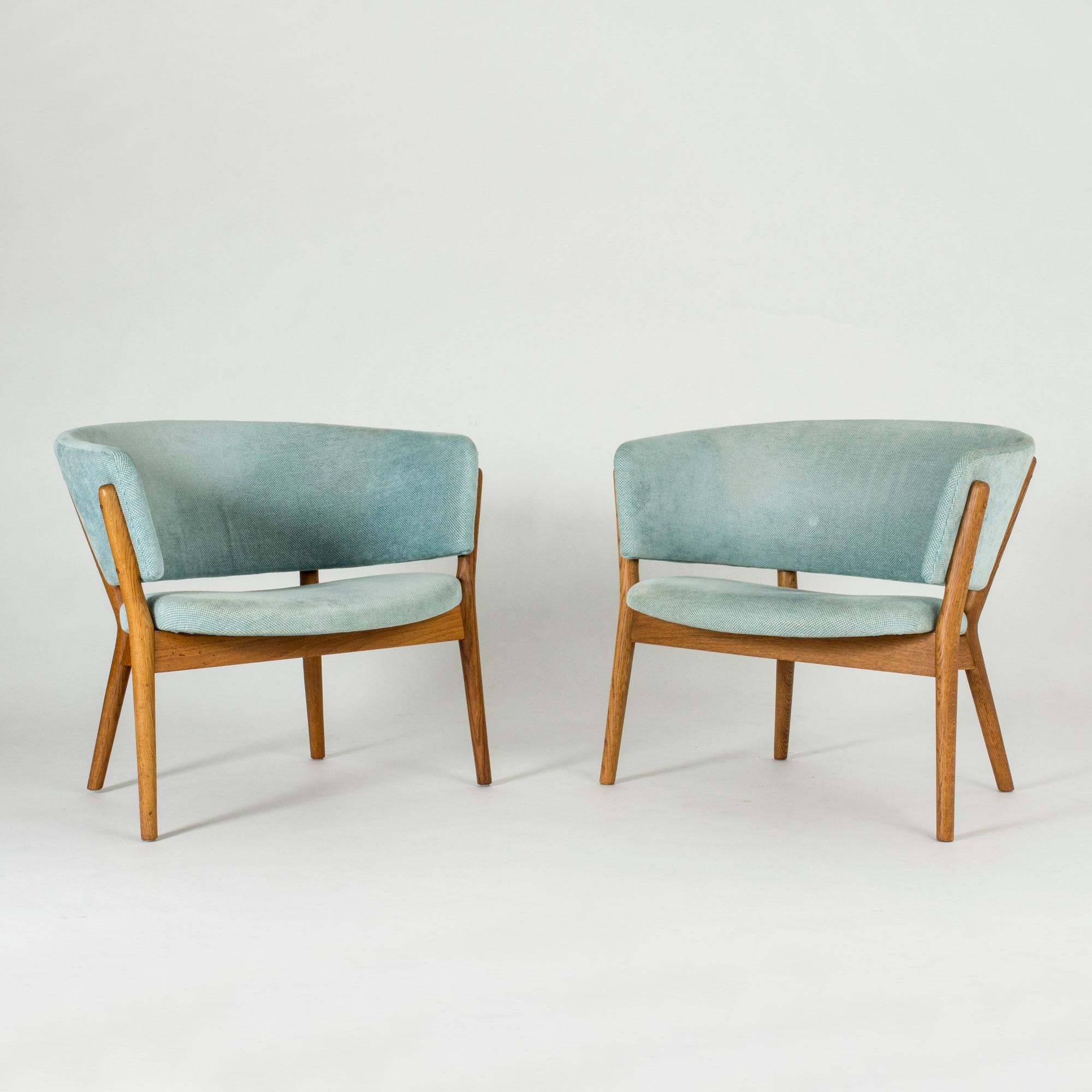 Pair of beautiful “ND 83” lounge chairs by Nanna Ditzel, designed in 1952. Frames made of solid oak, upholstered with a cool aquamarine colored vintage fabric. The elegant simplicity and inviting design are characteristic of Nanna Ditzel’s style.