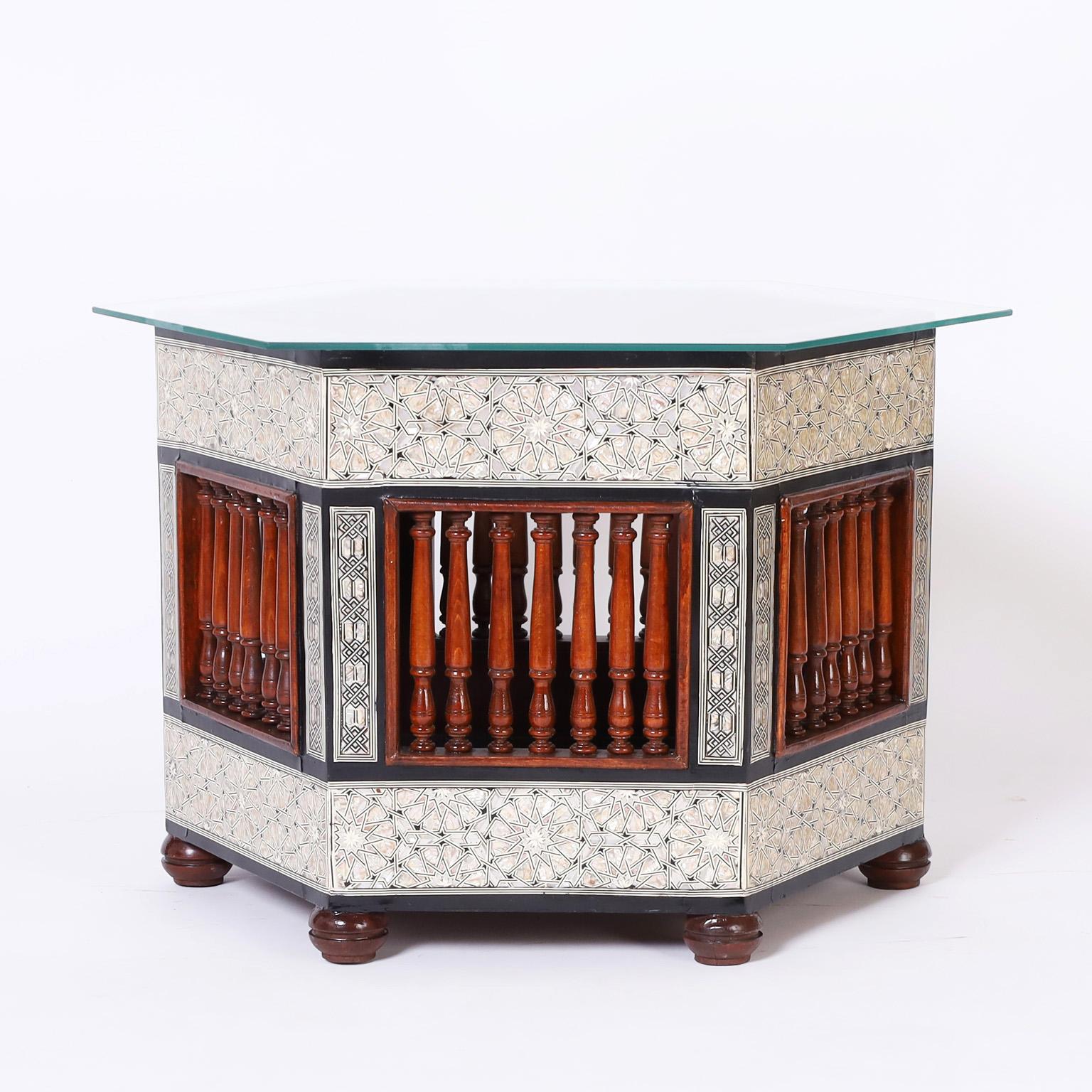 Pair of near eastern tables or stands crafted in indigenous hardwoods, once planters now tables featuring elaborate inlaid mother of pearl and ebony in geometric designs and turned mahogany balustrades.