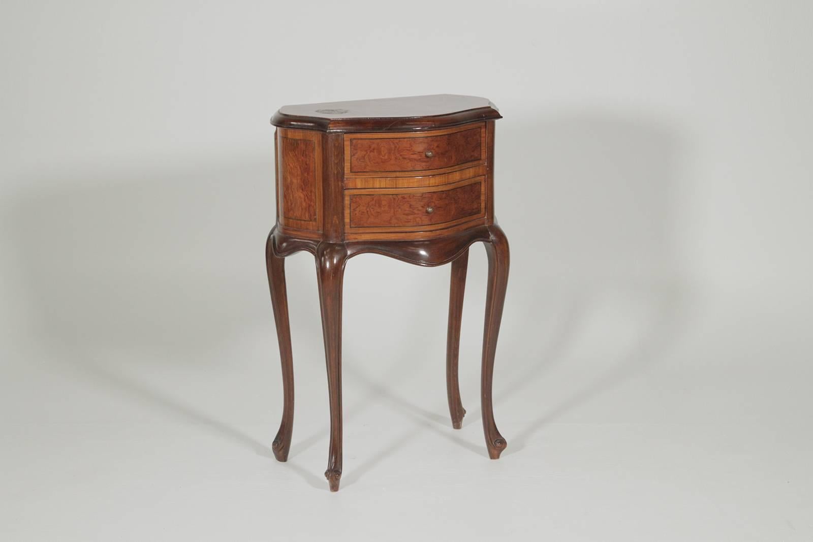 Pair of nearly matched two-drawer side tables each one with two working drawers in a burl mahogany, ebony and satinwood. The pairs is the same size and exact shape but with a slightly different inlay on the drawers.