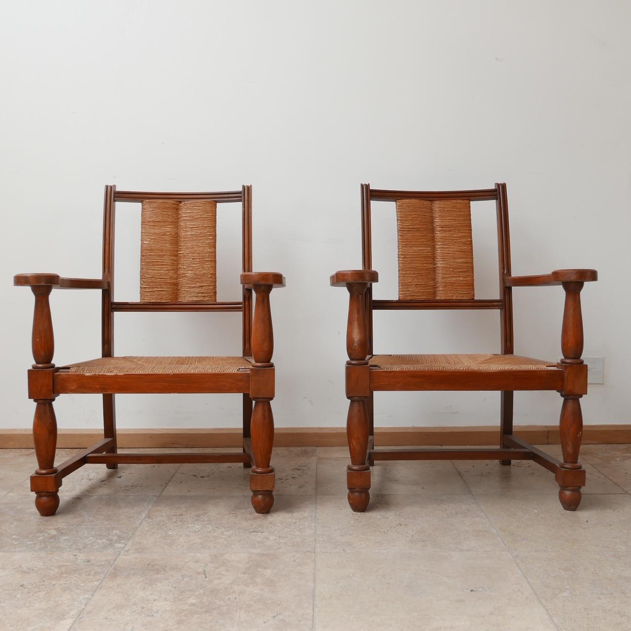A pair of Neo Basque style armchairs. 

France, c1950s. 

Wooden frame with rush back rest and seats. 

Generally good condition, some wear commensurate with age.

Price is for the pair. 

Dimensions: 62 W x 46 D x 35 Seat Height x 83