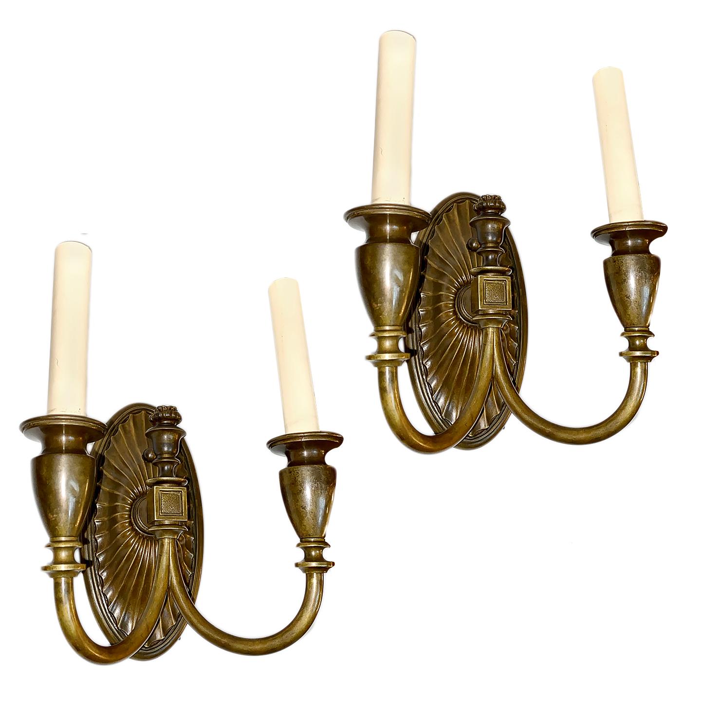 Pair of circa 1920s French neoclassic style two-light bronze sconces with original patina.

Measurements:
Height 11