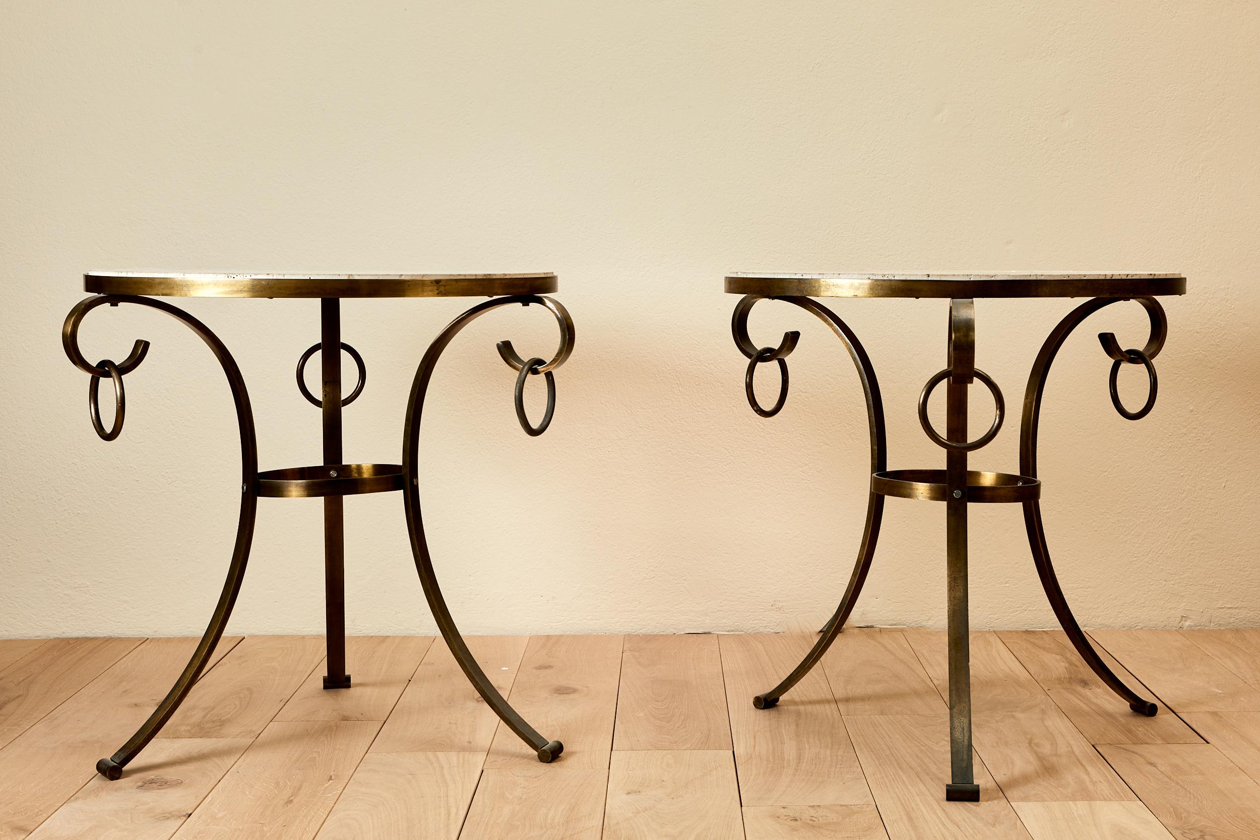 Pair of end table,
Wrought iron camber tripod base ending in a winding with a ring,
Travertin tray,
circa 1960, France. 

 