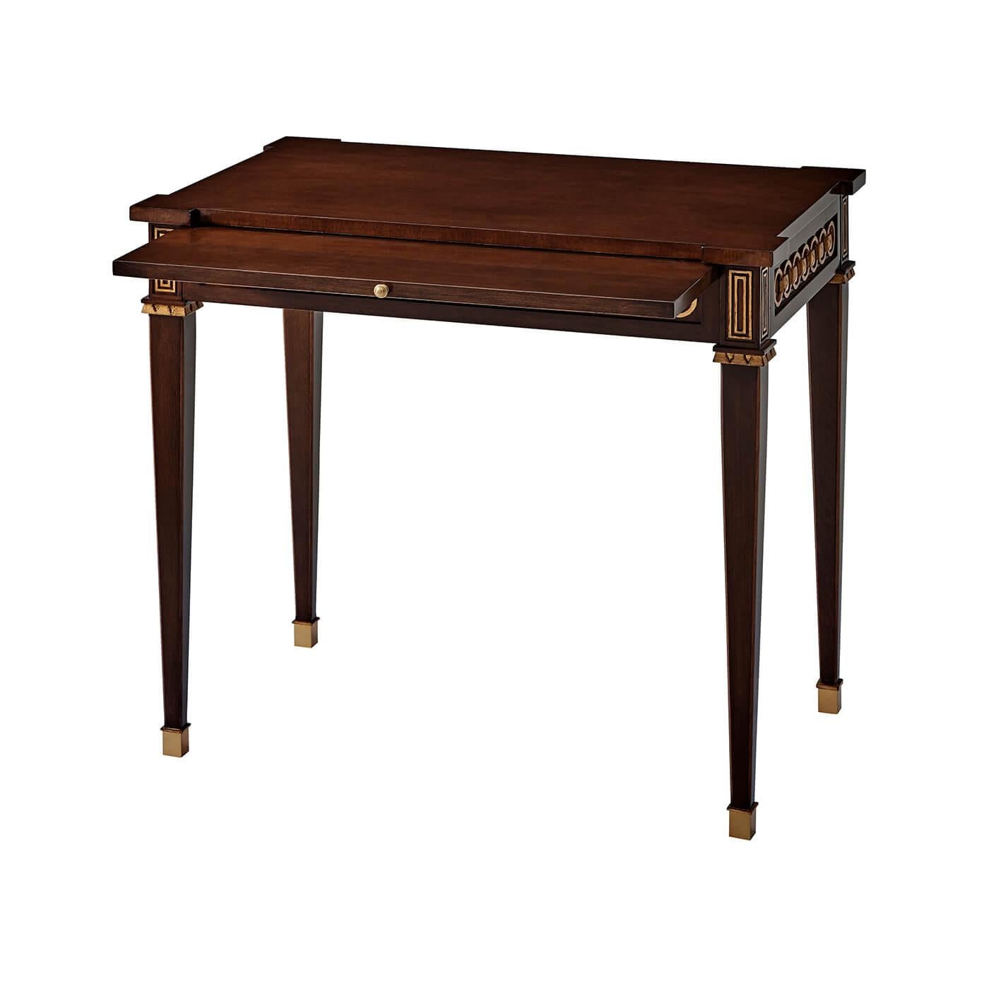 This neo-classic mahogany side table evokes historical models with familiar flourishes: interlocking rings and tapered legs capped in brass. With pyramid punctuation along the frieze apron, and a functional slide. Hand-brushed frieze details flesh