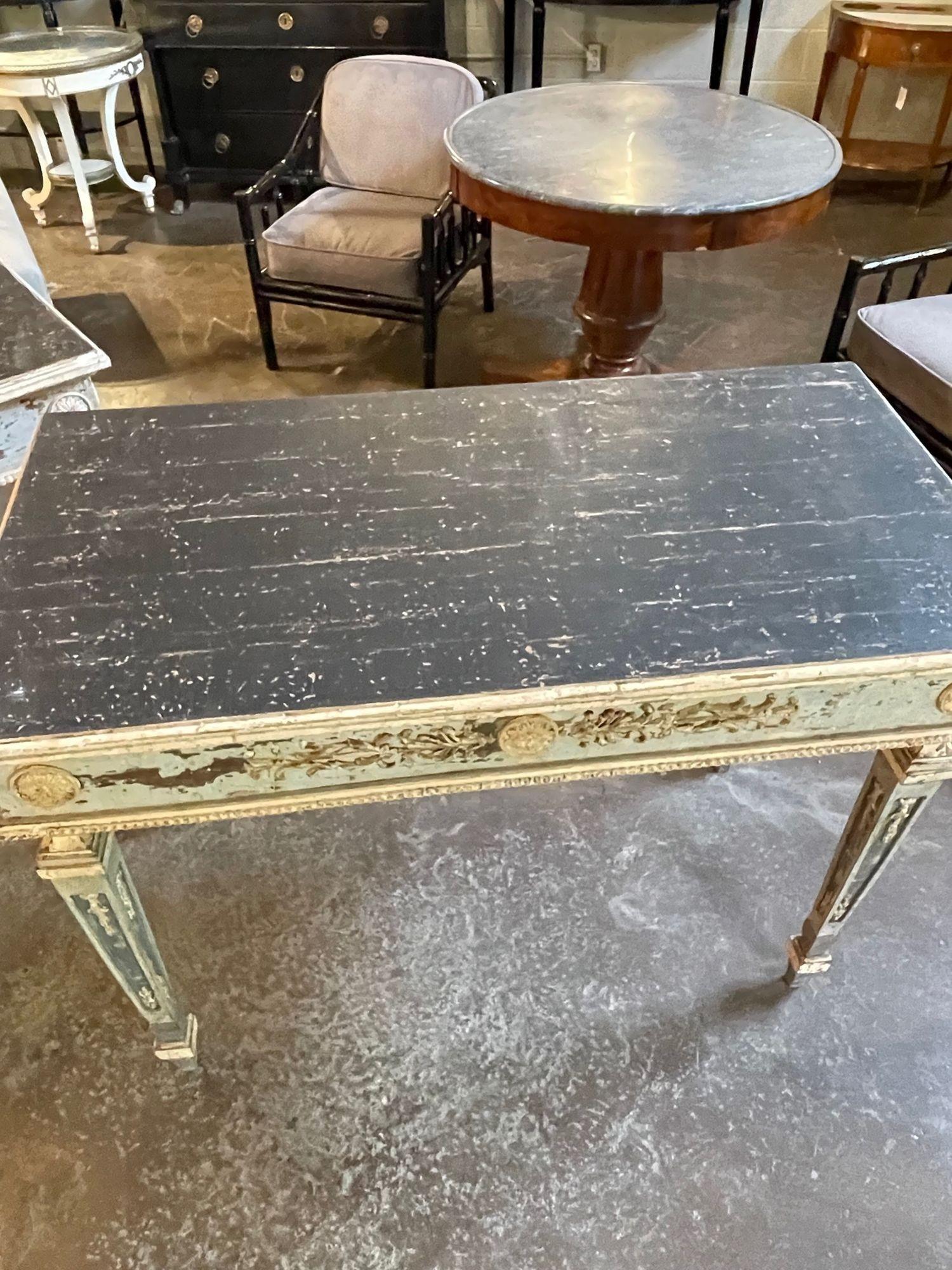 Exceptional pair of neo-classical carved and painted consoles. The consoles are made of antique fragments. Beautiful patina in the colors of creme, aqua and black. A truly fine pair for an upscale home!