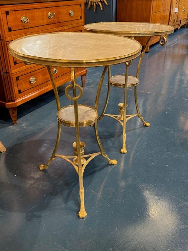 This pair of Neo-Classical gilt bronze and marble side tables exudes elegance and sophistication. These beautiful tables make a stylish statement while maintaining a timeless and classic aesthetic. Superb!  Circa 1970
20.5w x 27.5h