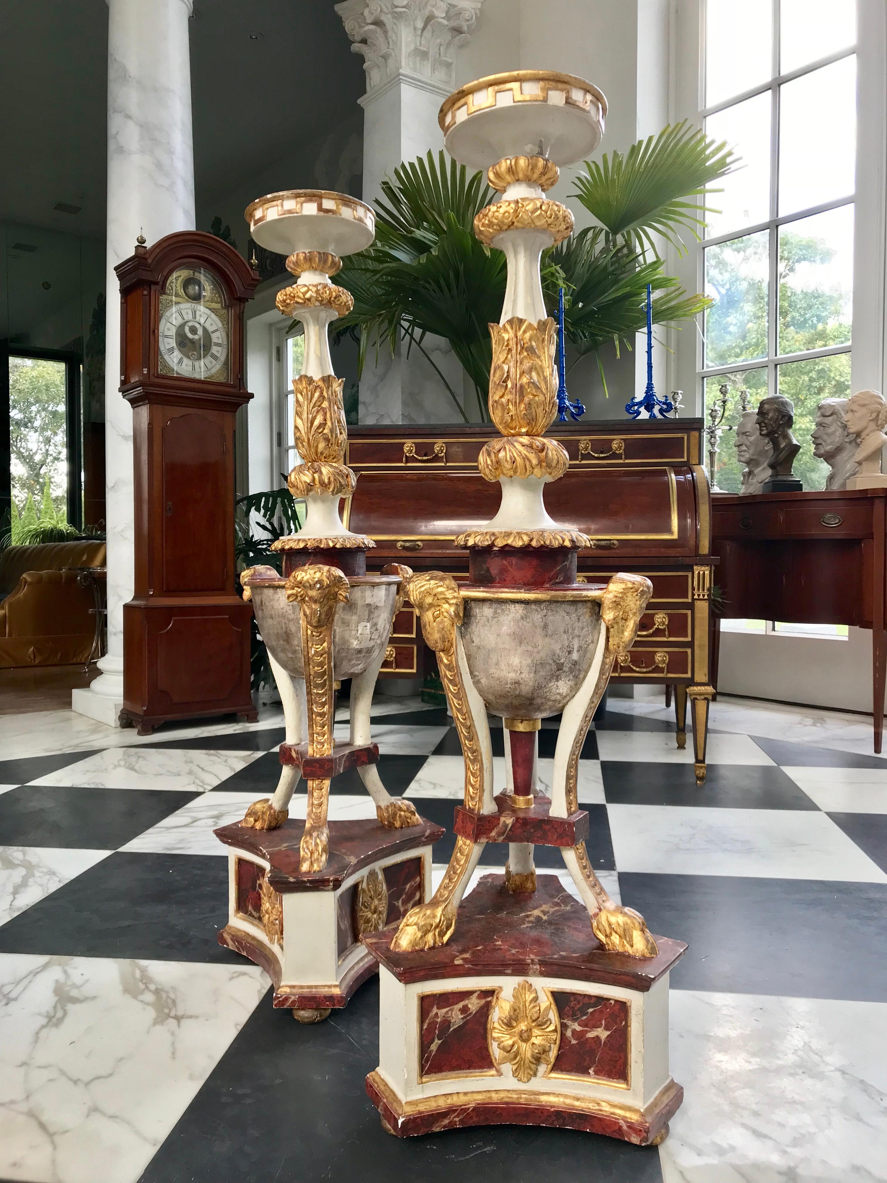 This beautiful pair of neoclassical hand carved Torchères were made in the early 19th century in Italy. They are gilded in silver and gold, faux painted in Rouge marble and off white.