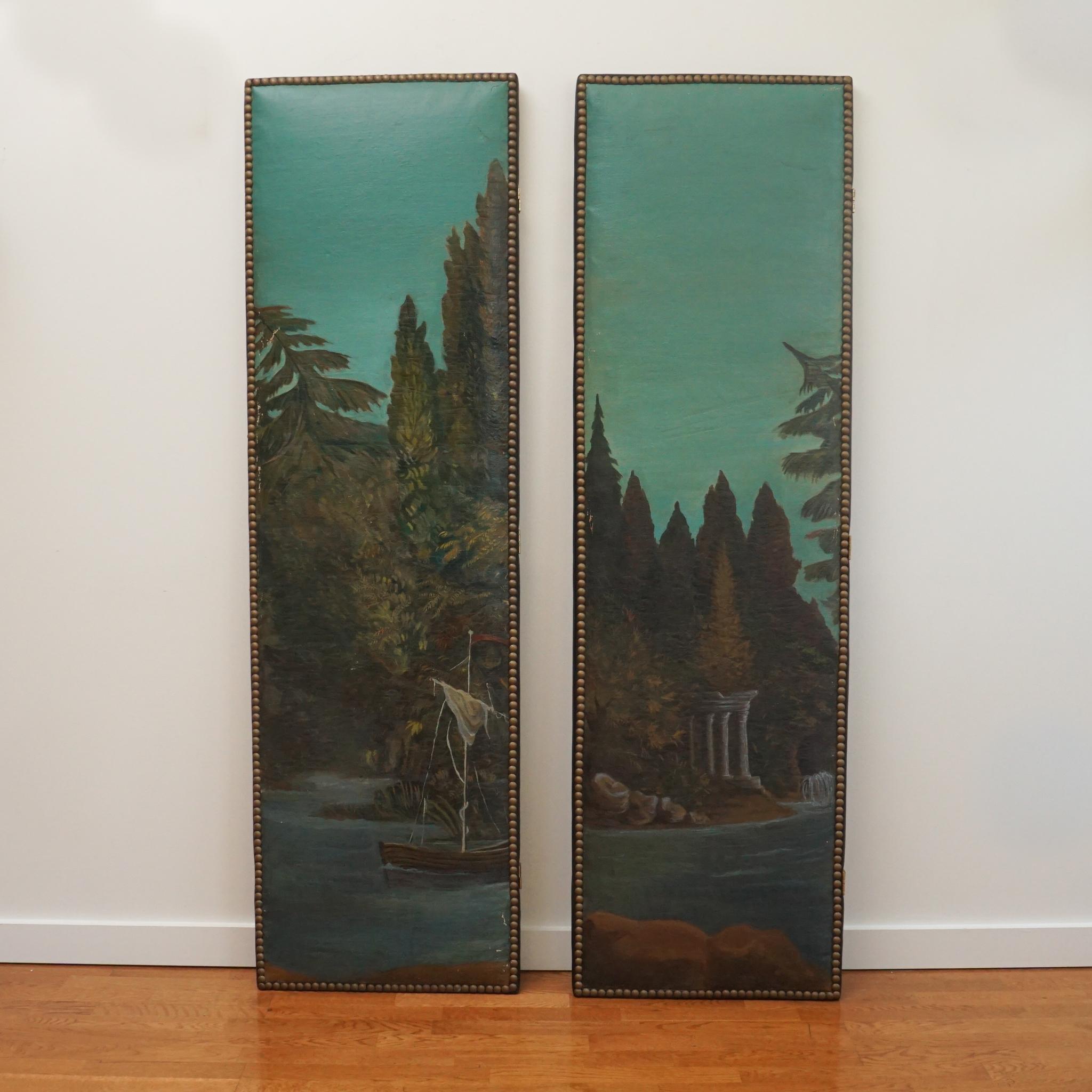 The pair of vintage painted canvas panels, shown here, are notable for their beauty and condition. Depicting a bucolic outdoor scene, the imagery has maintained good color over time. Each panel is mounted on a wood board and outlined with a nail