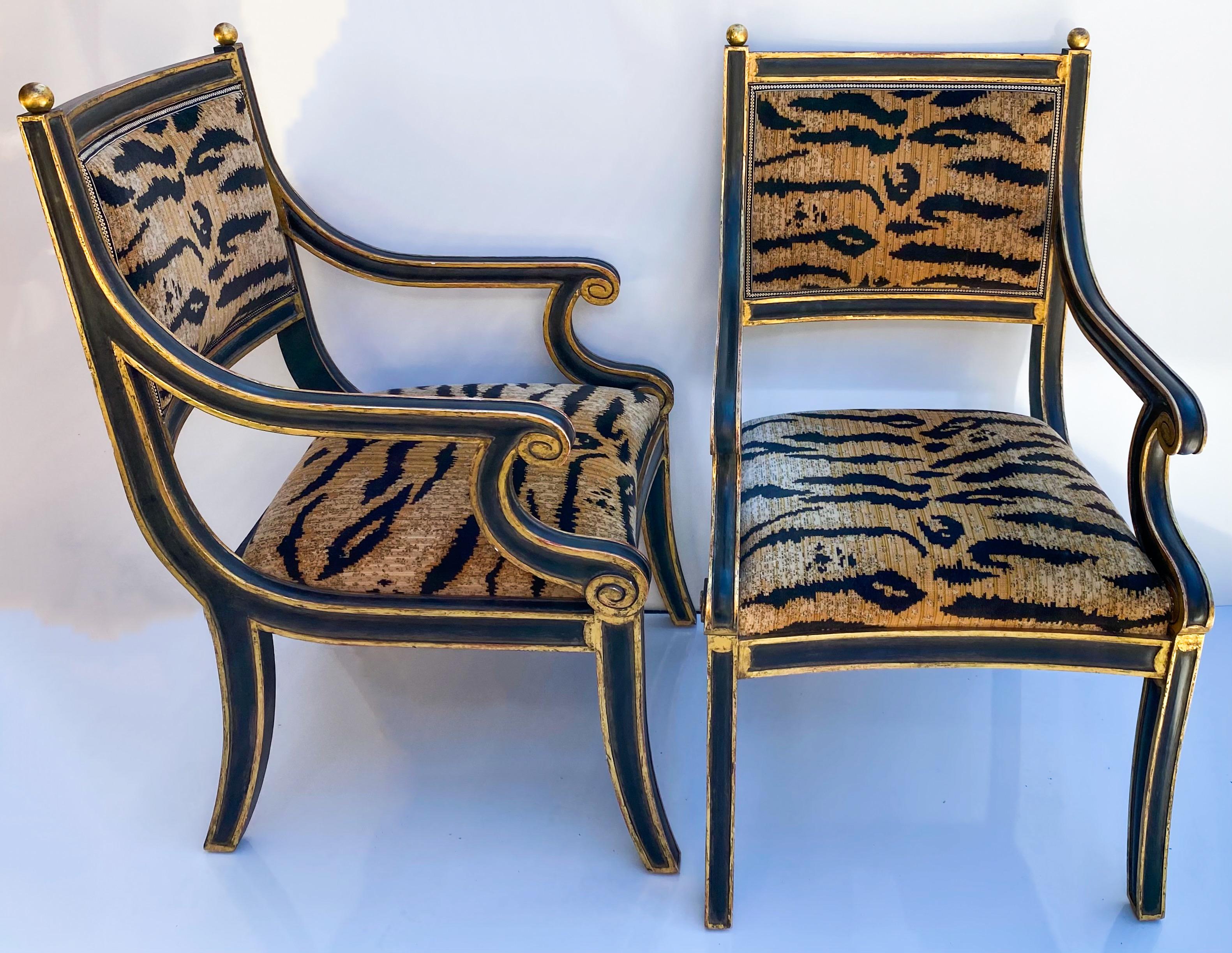 This is a pair of late 20th century pair of neoclassical style chairs upholstered in a tiger velvet. They have giltwood and ebony frames. They were designed by Jerry Pair for Formations. They are marked and in excellent condition.