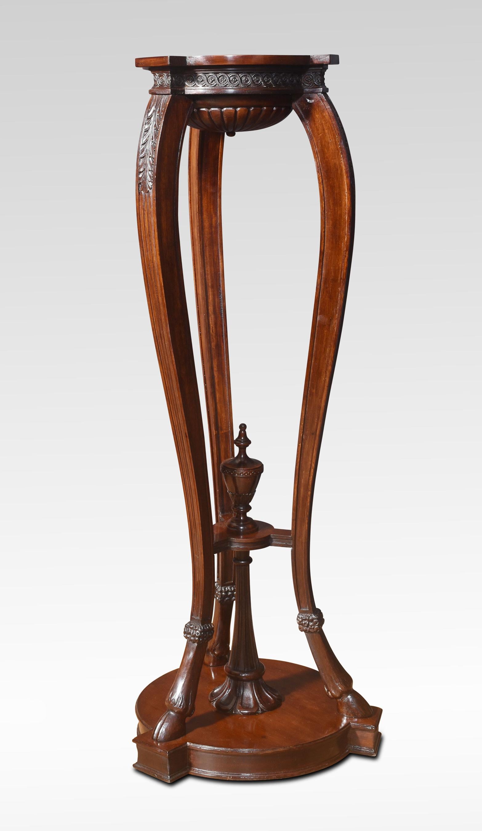 Pair of Neo classical style carved mahogany torcheres the shaped tops and carved frieze with guilloche and acanthus leaves detail. To the shaped legs united by under-tier with central urn. All raised up on Hoof feet and moulded
