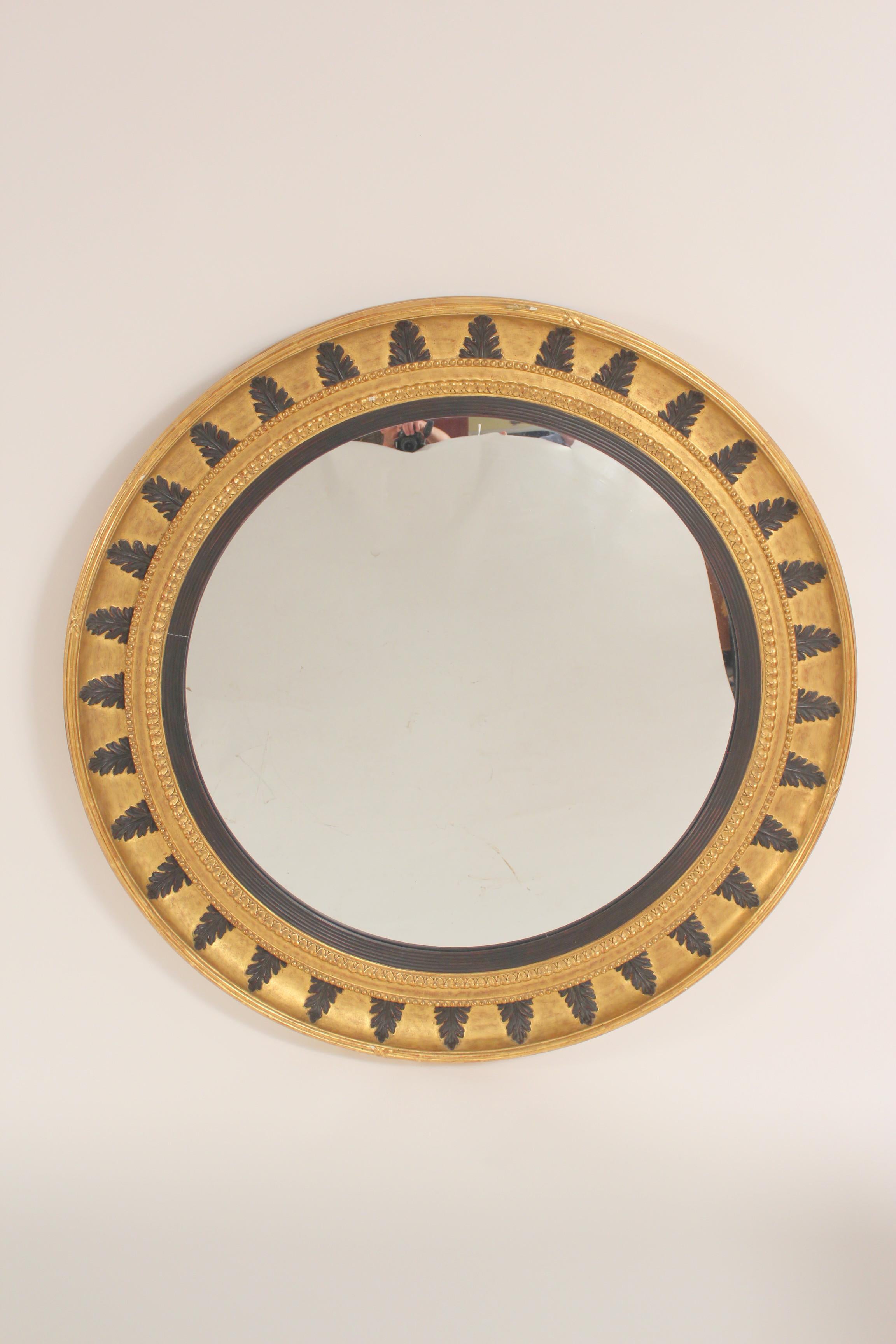 Pair of neo classical style gilt wood bulls eye mirrors, circa late 20th century.