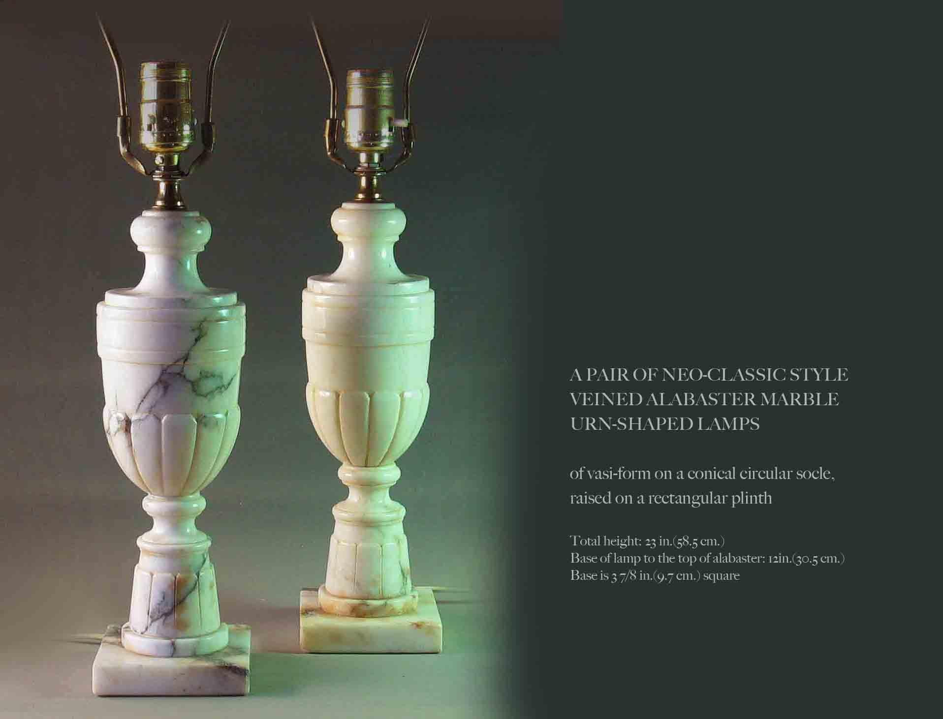 A pair of neoclassical veined alabaster marble urn shaped table lamps, in a vase or vasi form on a conical circular socle, raised on a rectangular plinth.
The lamps measure:
Lamps total height 23