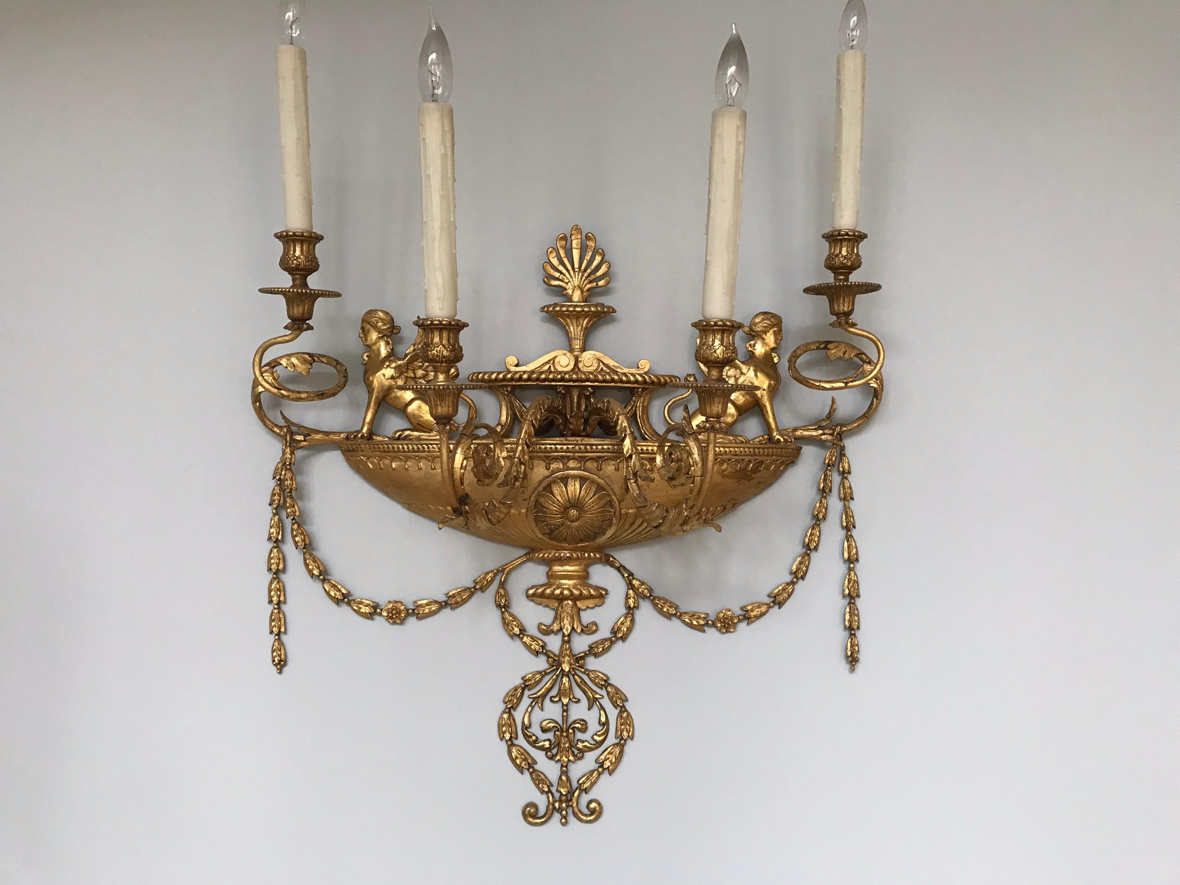 A fine pair of English Adam’s period four arm wall sconces. Robert Adam (1728-1792) incorporated strong neoclassical elements from all the recent discoveries in Pompeii & Herculaneum, for example the Sphynxes, the light swags of laurels and the use