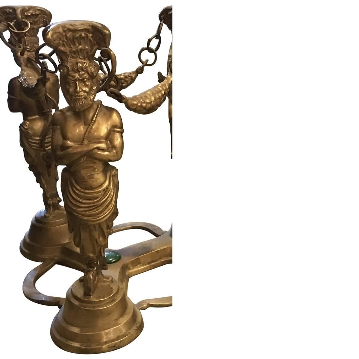 Inspired by the majesty of ancient Greek architecture and art, these Neo-Grec table bases. Antiques. Both are made of bronze with three sculpted male figures acting as supports. Central struts each decorated with a single stone jewel add to their
