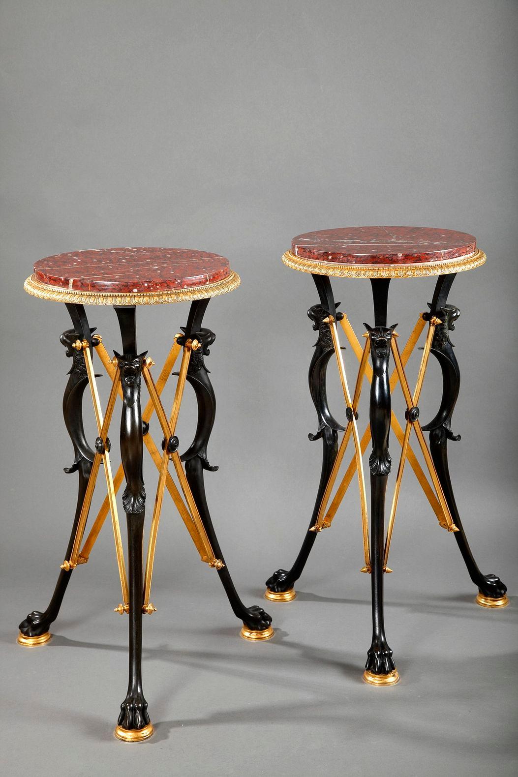 Pair of patinated and gilded bronze high guéridon attributed to L.C Sevin and F. Barbedienne, with for each of them, three paw feet joined by X shaped stretchers. Round red griotte marble top mounted with a bronze rim, adorned with ove and pearl