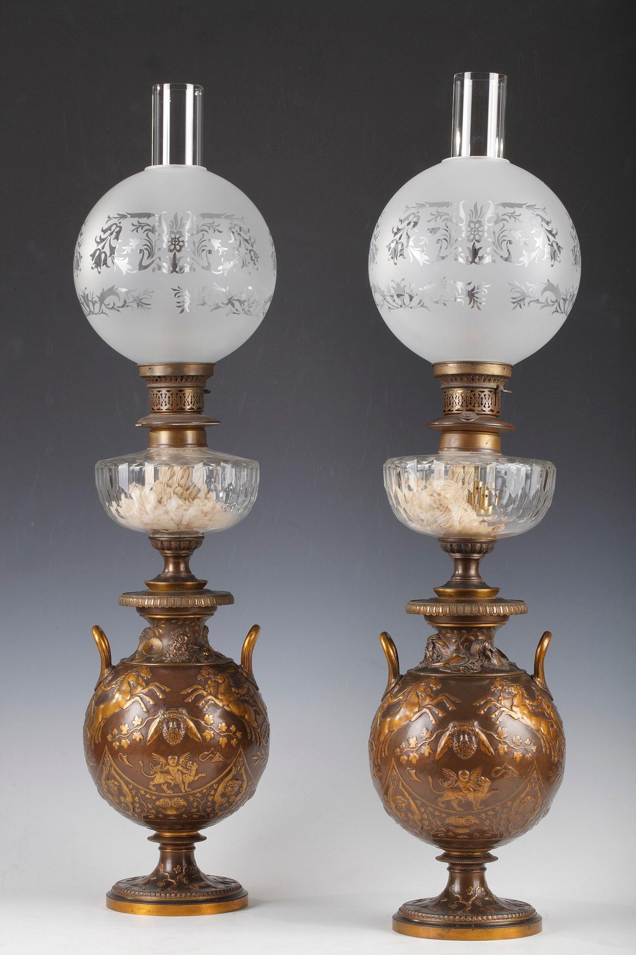 Signed F. Levillain inv. and F. Barbedienne

Pair of two patina bronze lamps made in shape of ancient vases. A rich decor made in low-relief depicts scenes in the ancient style, such as gods riding their chariots and cupids holding up cups and