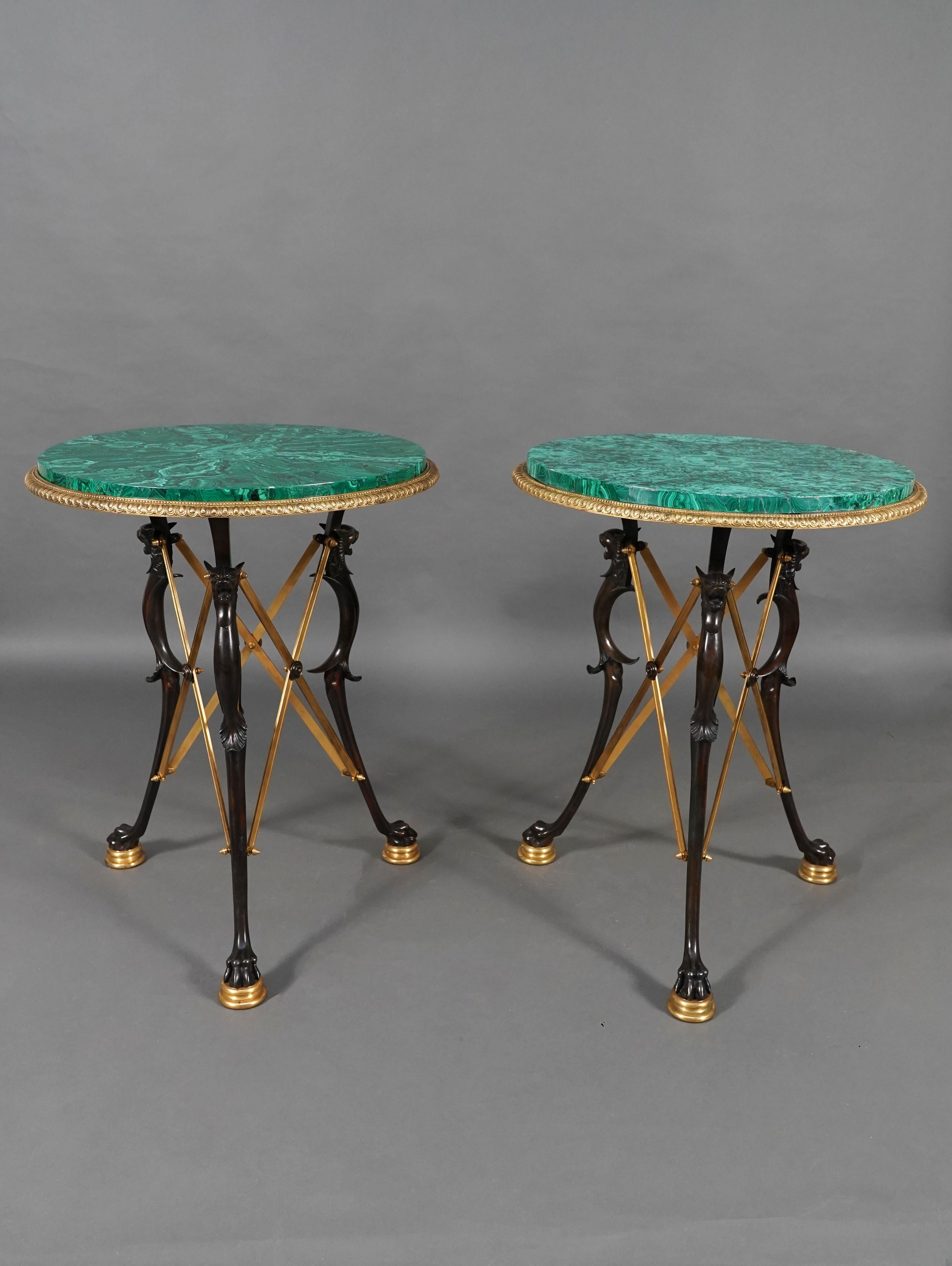 A similar model was exhibited at the 1889 Paris Universal Exhibition.
Rare pair of round table made of patinated and gilded bronze with a top veneered with malachite and circled with bronze mounts adorned with ovum and beads. They stands on three