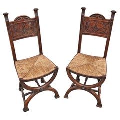 Pair of Neo-renaissance Side Chairs in oak with rush seats, France 1910s