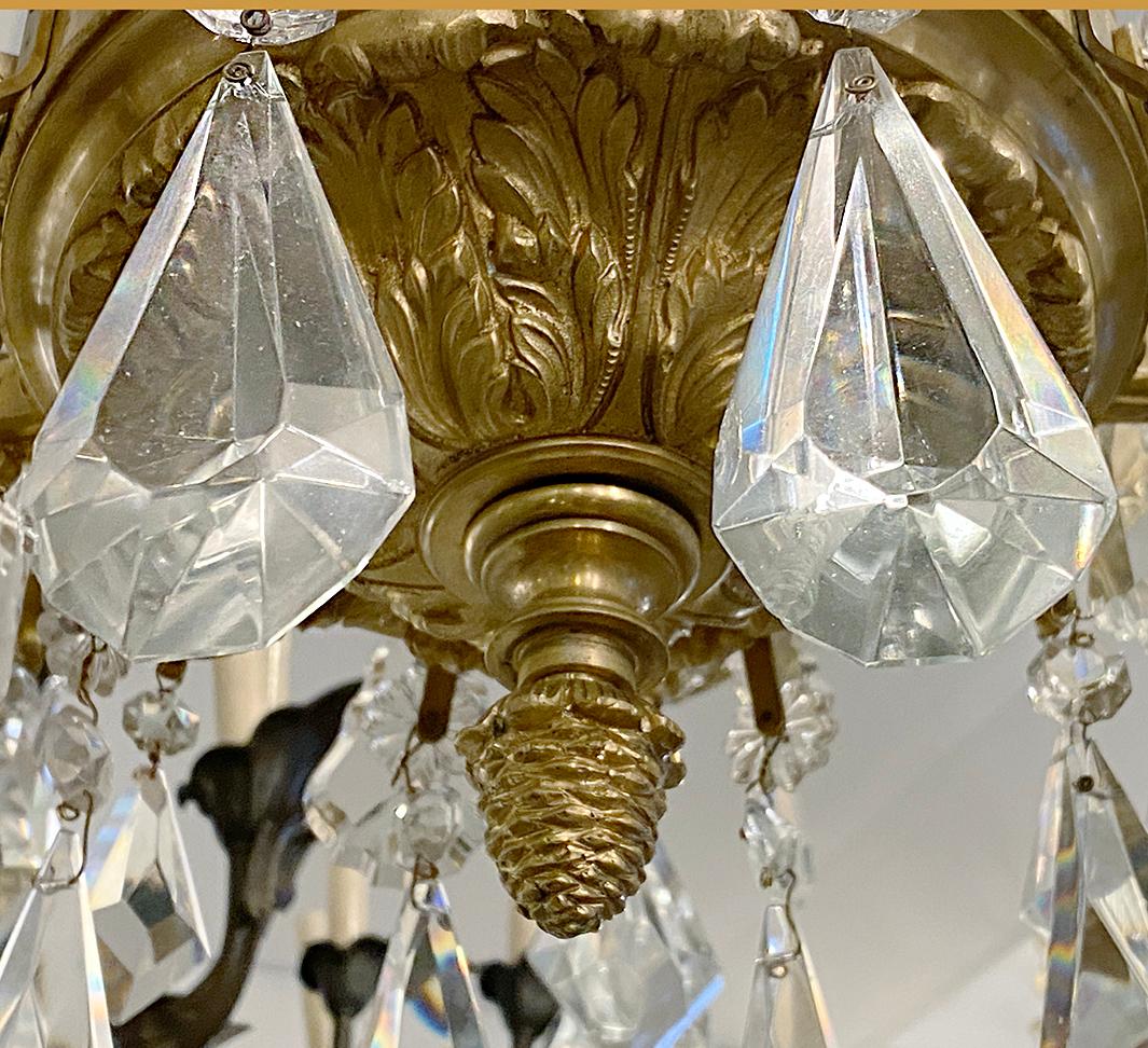 A pair of French circa 1920's fifteen-arm gilt bronze neoclassic style chandeliers with crystal pendants. Sold individually.

Measurements:
Current drop: 58