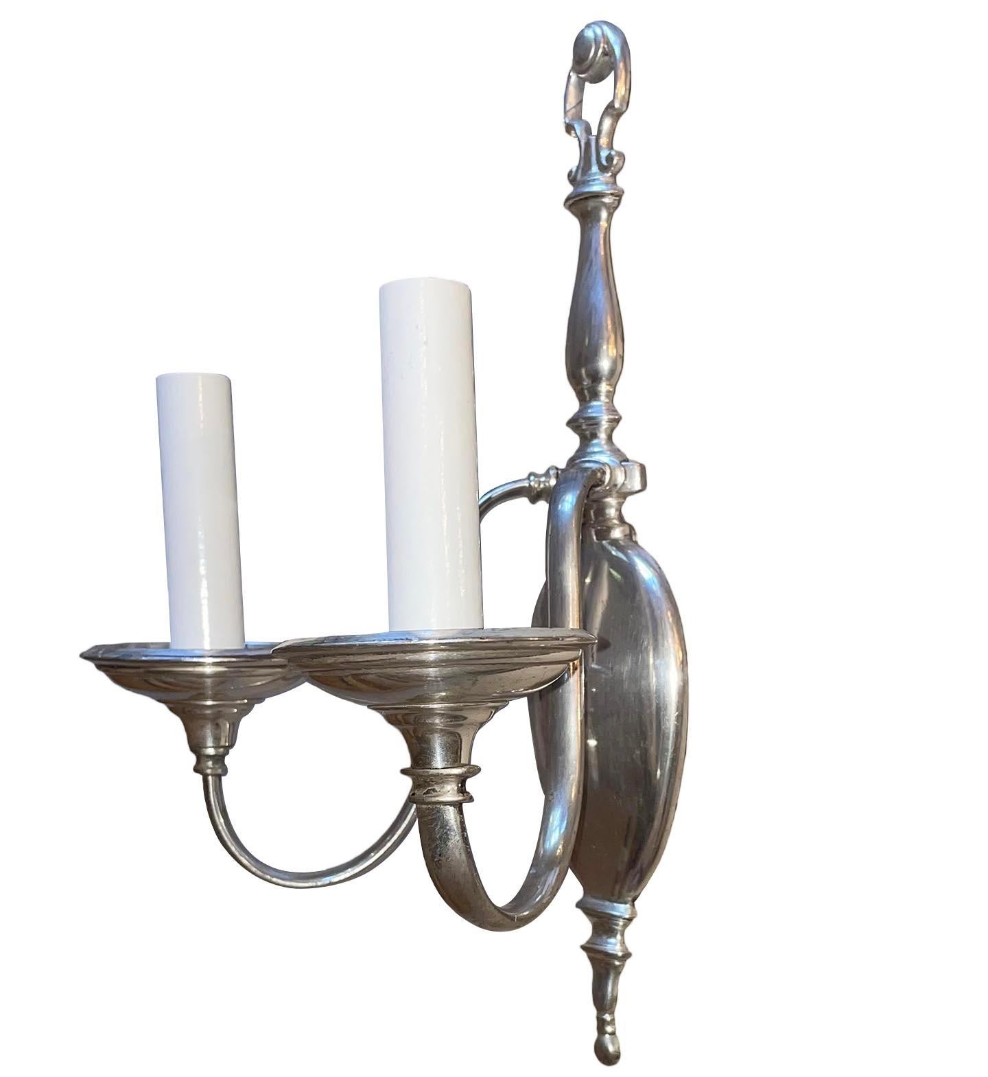 Pair of circa 1920's American neoclassic style silver plated sconces.
Measurements:
Height: 13.75