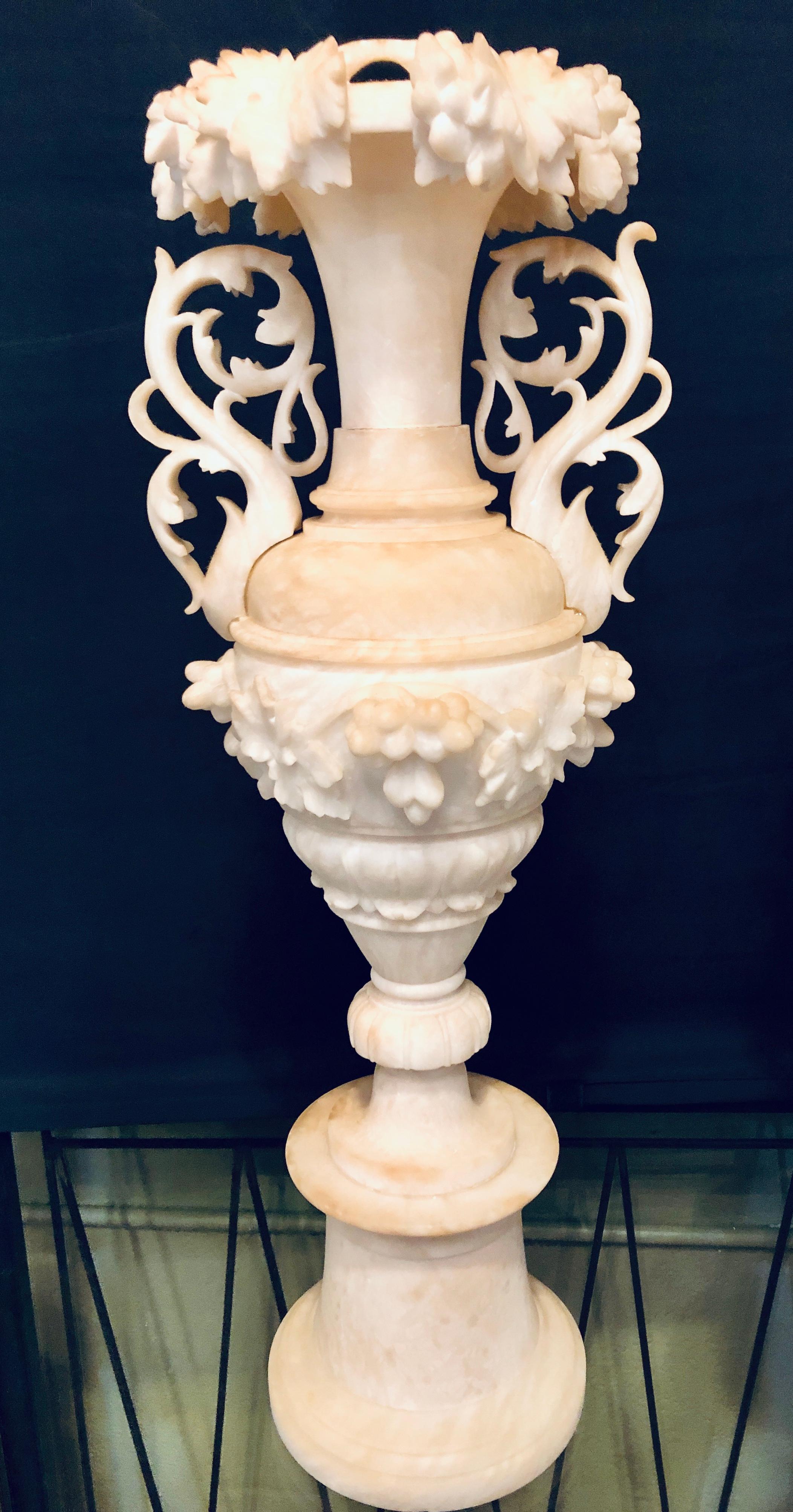 Pair of neoclassical 19th century alabaster three-piece urns or vases. This fine classical designed pair of table urns or vases are simply stunning with their pierced handled and grape on the vine design. Having old repairs as one would expect these