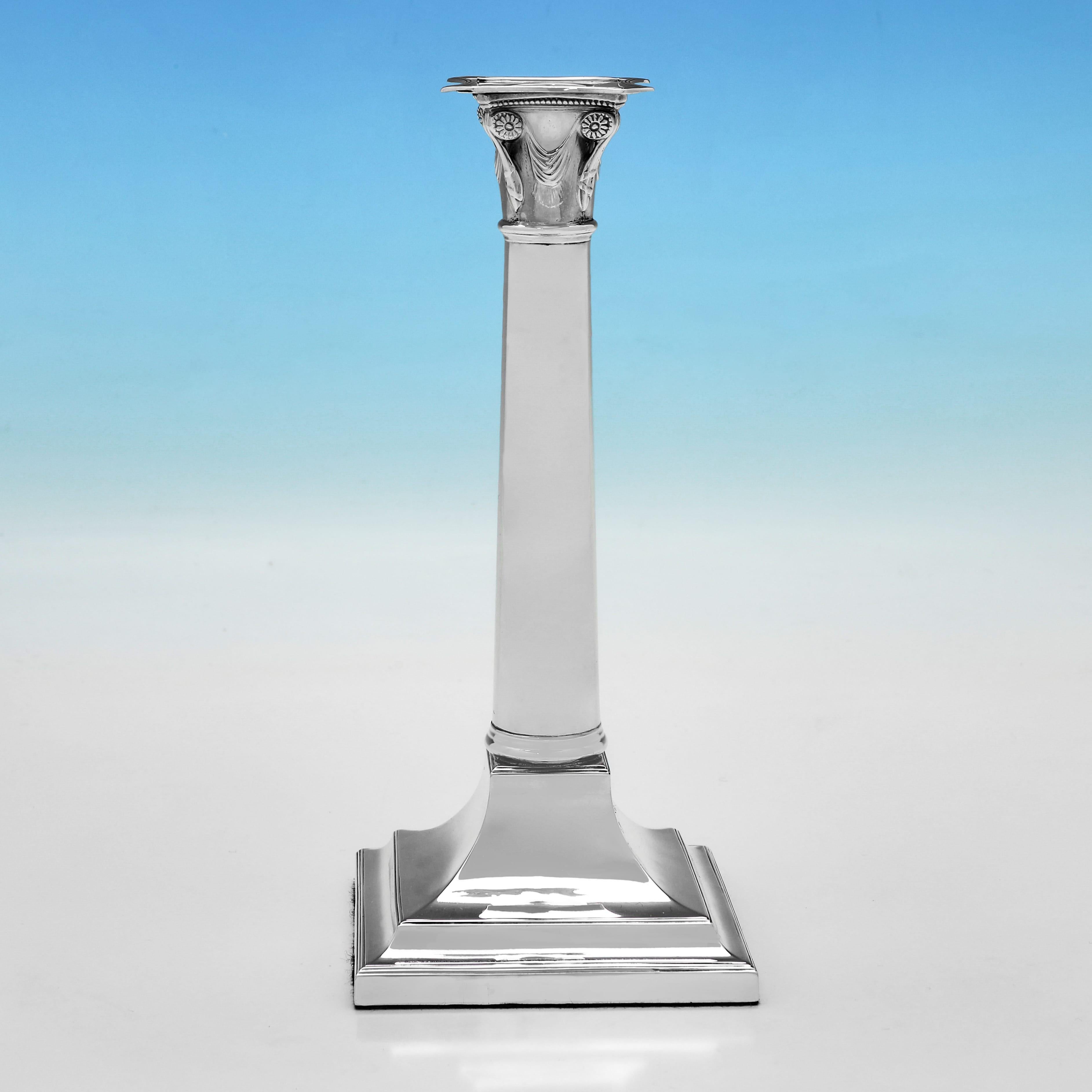 Hallmarked in Sheffield in 1921 by Thomas Bradbury & Sons Ltd, this handsome pair of antique, George V period, Sterling Silver Candlesticks, are plain in design, with neoclassical decoration to the capitals, and removable nozzles. Each candlestick