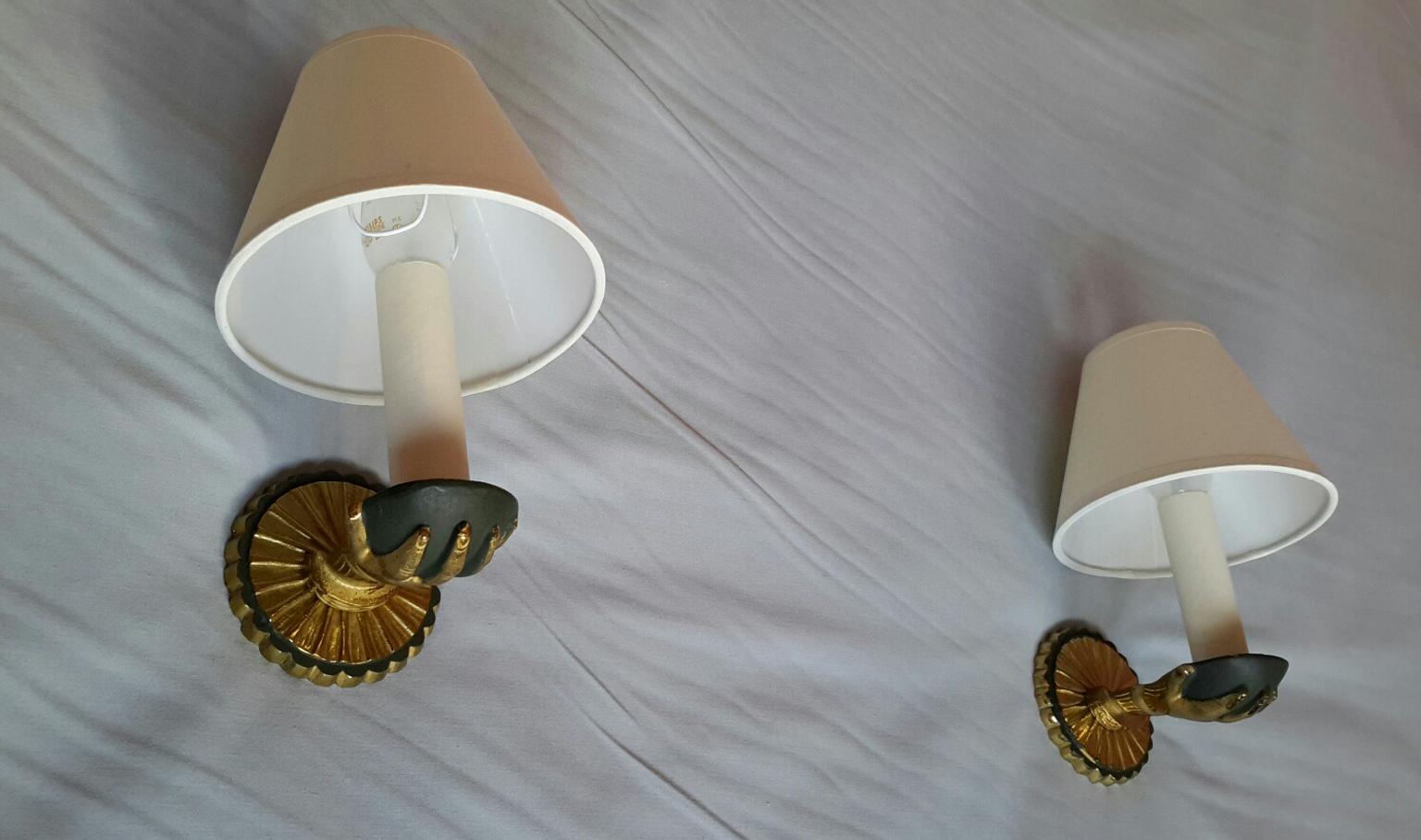 Beautiful and original pair of neoclassical gilt bronze sconces and antique green patina with white ivory cotton lampshades representing a child hands in the style of Maison Baguès / Jansen, France, 1950s.

In an excellent original condition and a