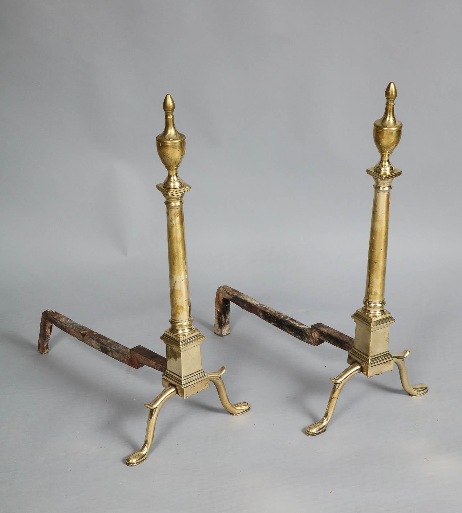 Fine pair of 18th century neoclassical brass andirons having urn finials over doric column shafts, standing on square plinth bases having cabriole legs with spurs over shoe feet.

Possibly Philadelphia, circa 1780.