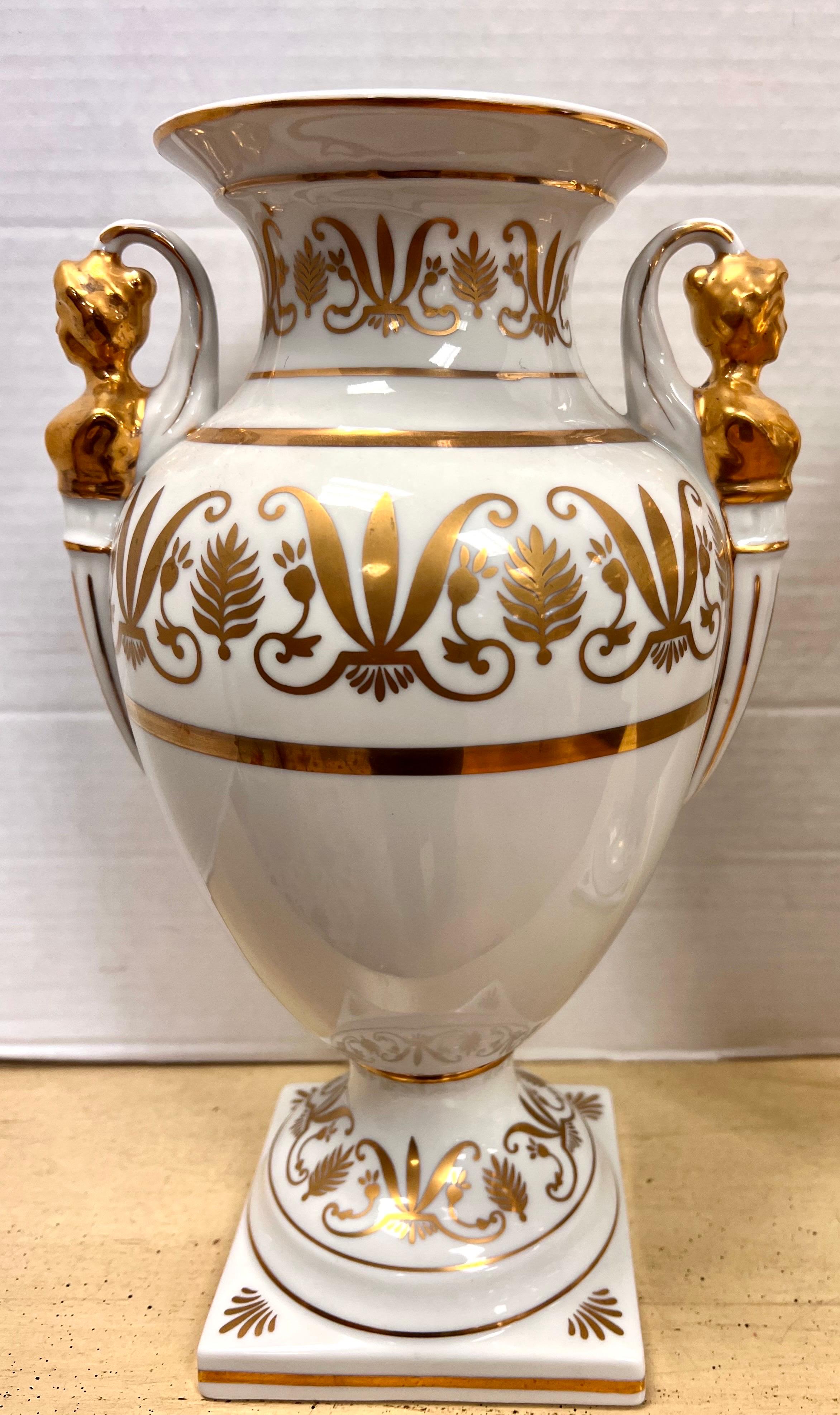 Gorgeous pair of campana porcelain urns with gold decoration and female figural handles. Each numbered on the bottom.