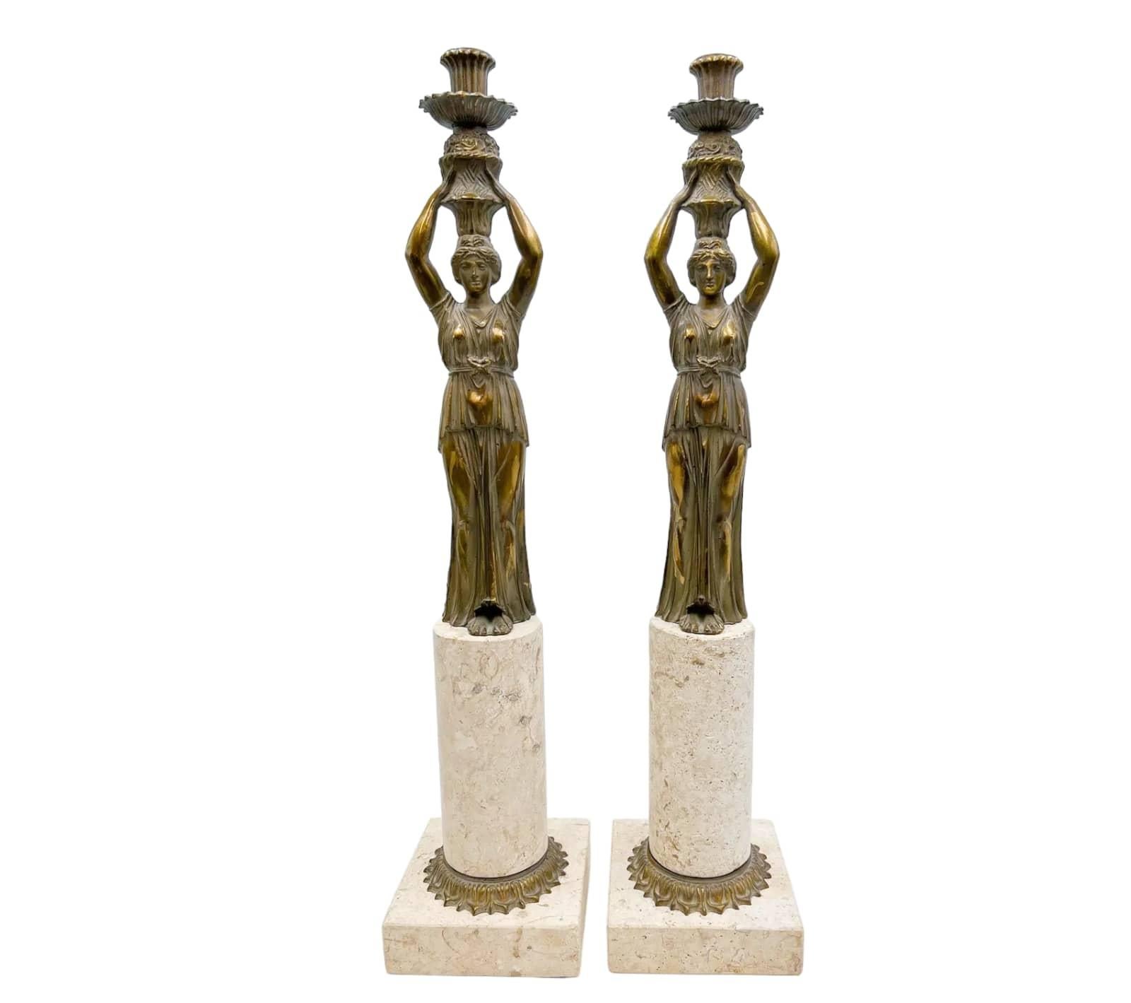 Introducing a pair of solid brass and limestone candleholders., characteristic of the Neoclassical and Art Nouveau styles. The figural candleholders are mounted on a limestone base, creating a visually striking combination of materials.

Condition: