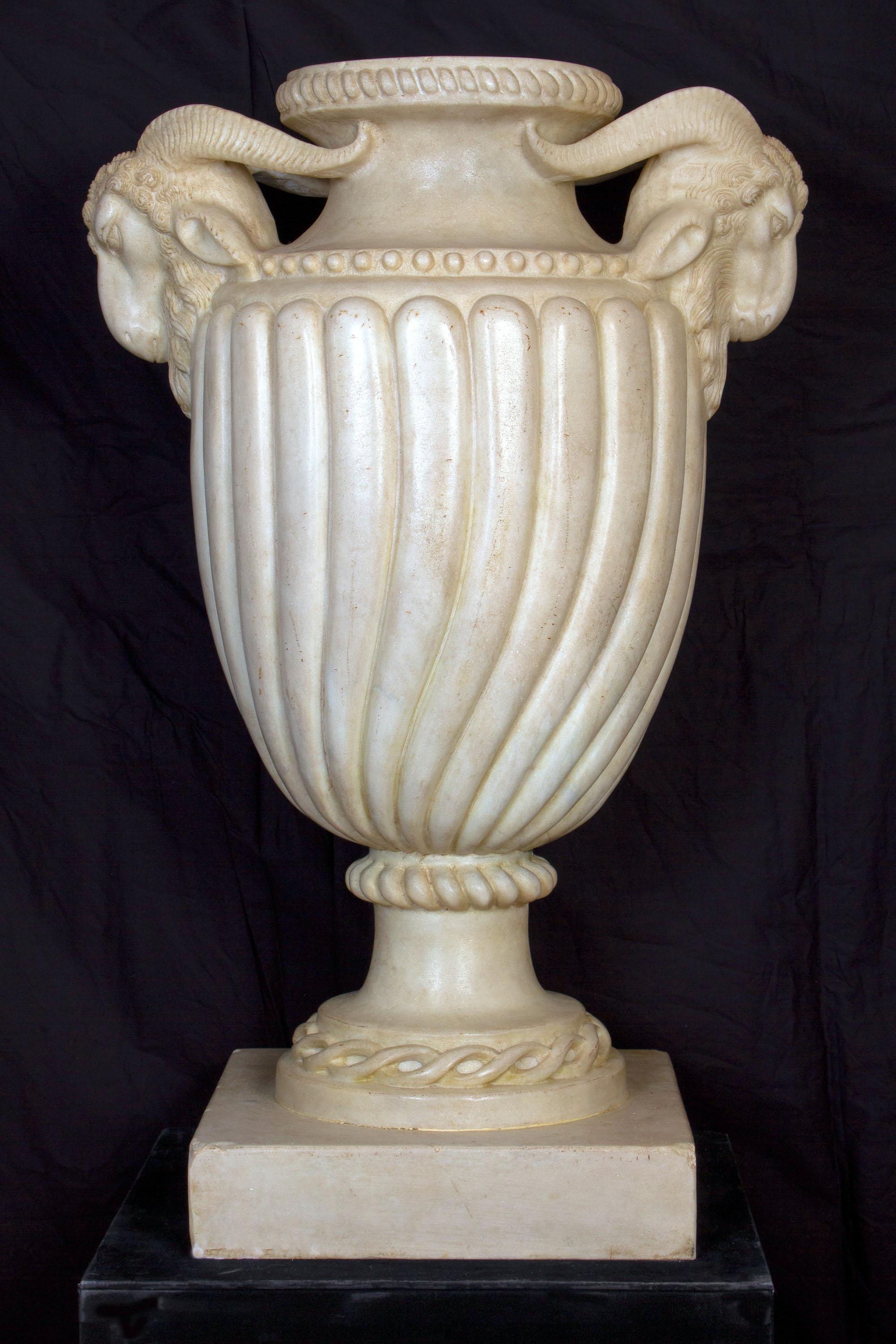 A very rare pair of neoclassical finely carved white Carrara marble vases. Each featuring a bulbous shape.
The handles detailed decorated with goat heads.
Sophisticated ornament for your interior.